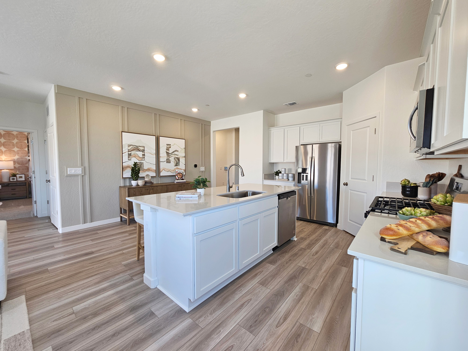 A kitchen with white cabinets.