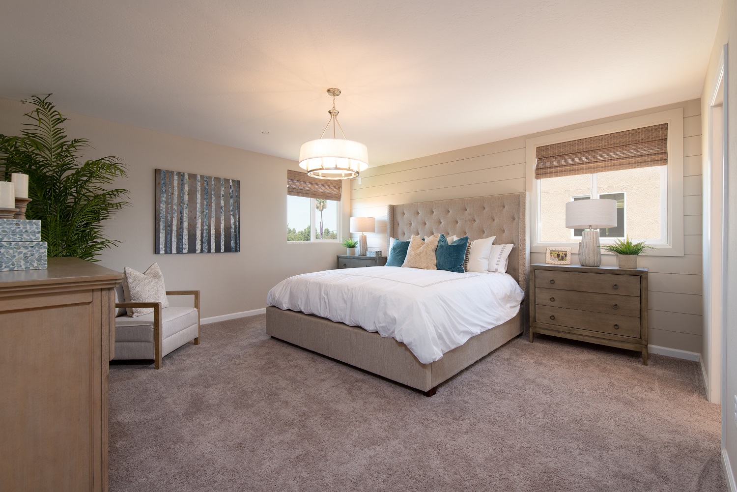 A bedroom with a bed and a chair.