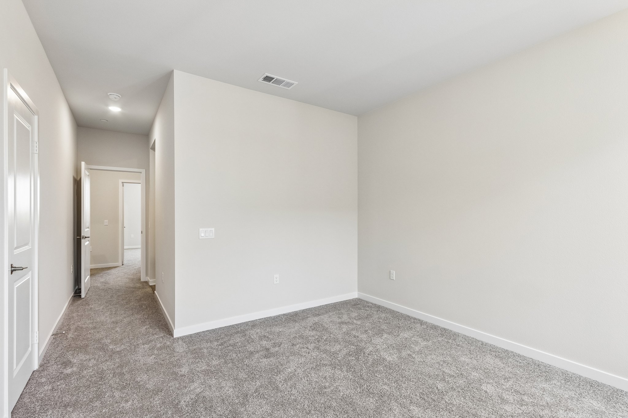 A hallway with white walls.
