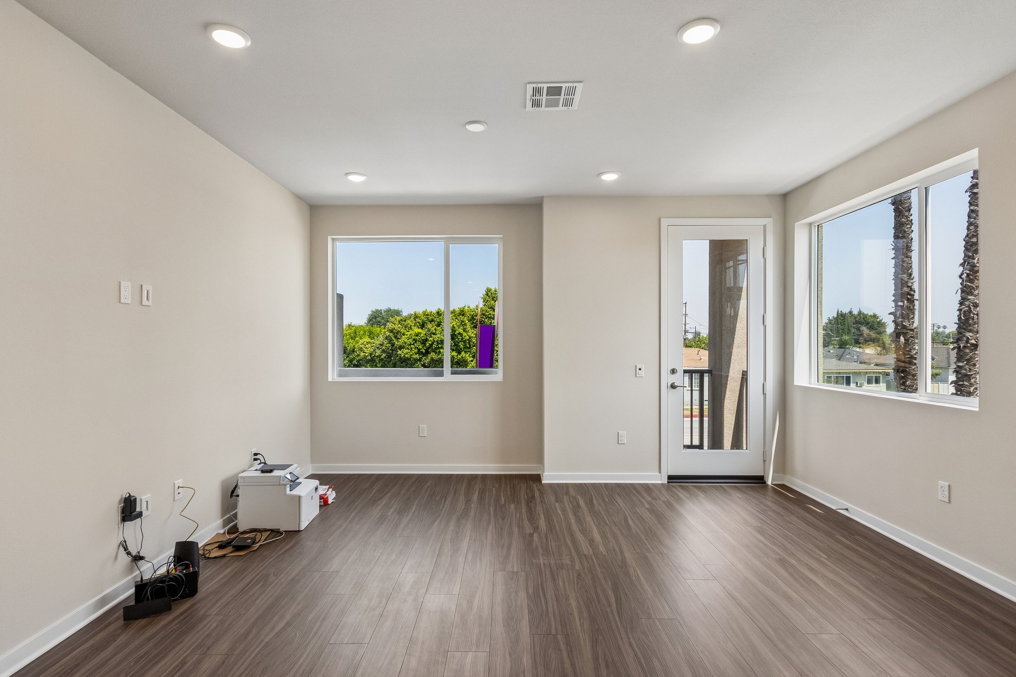 A room with a wood floor and windows.