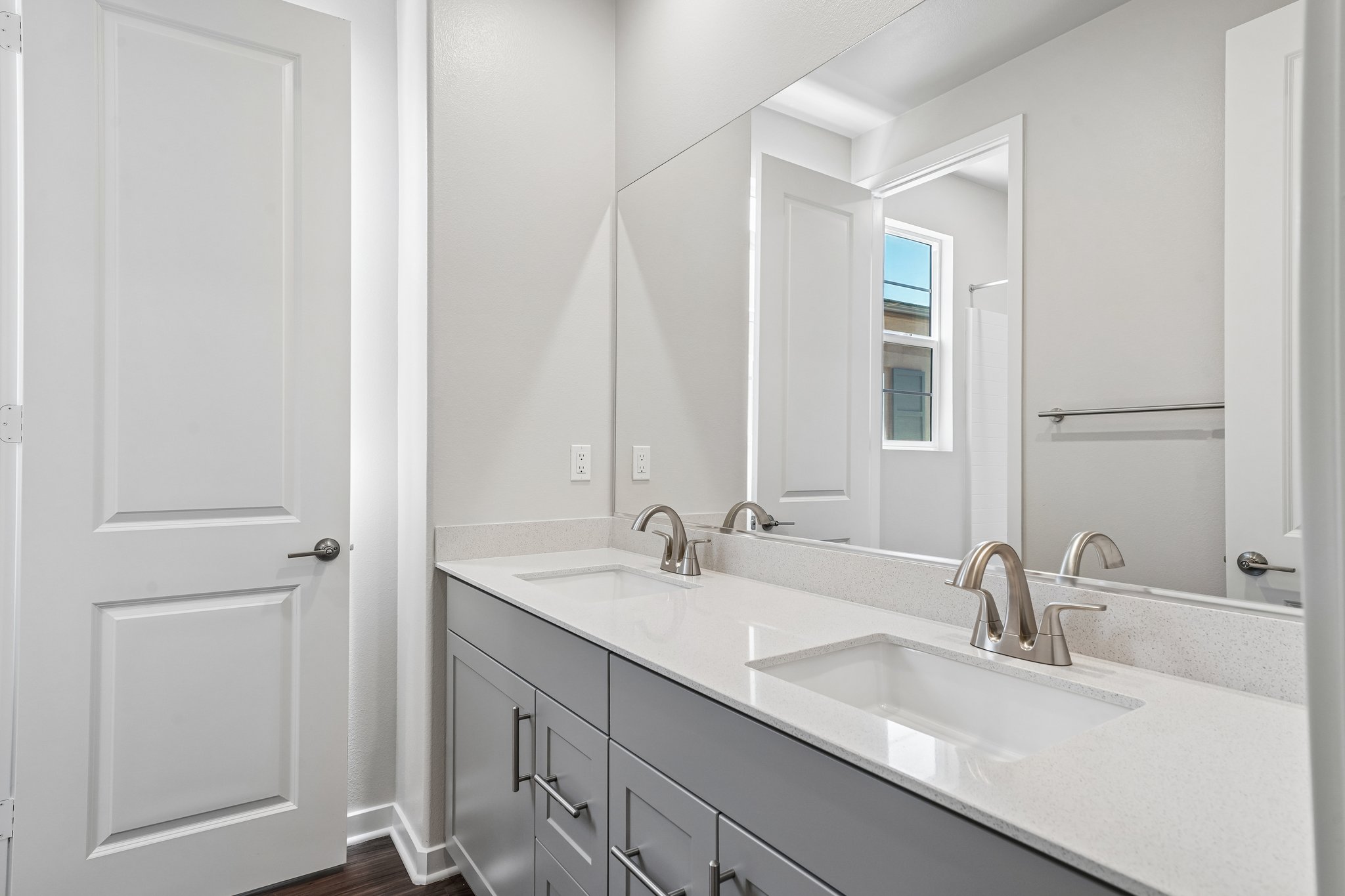 A bathroom with a large mirror.