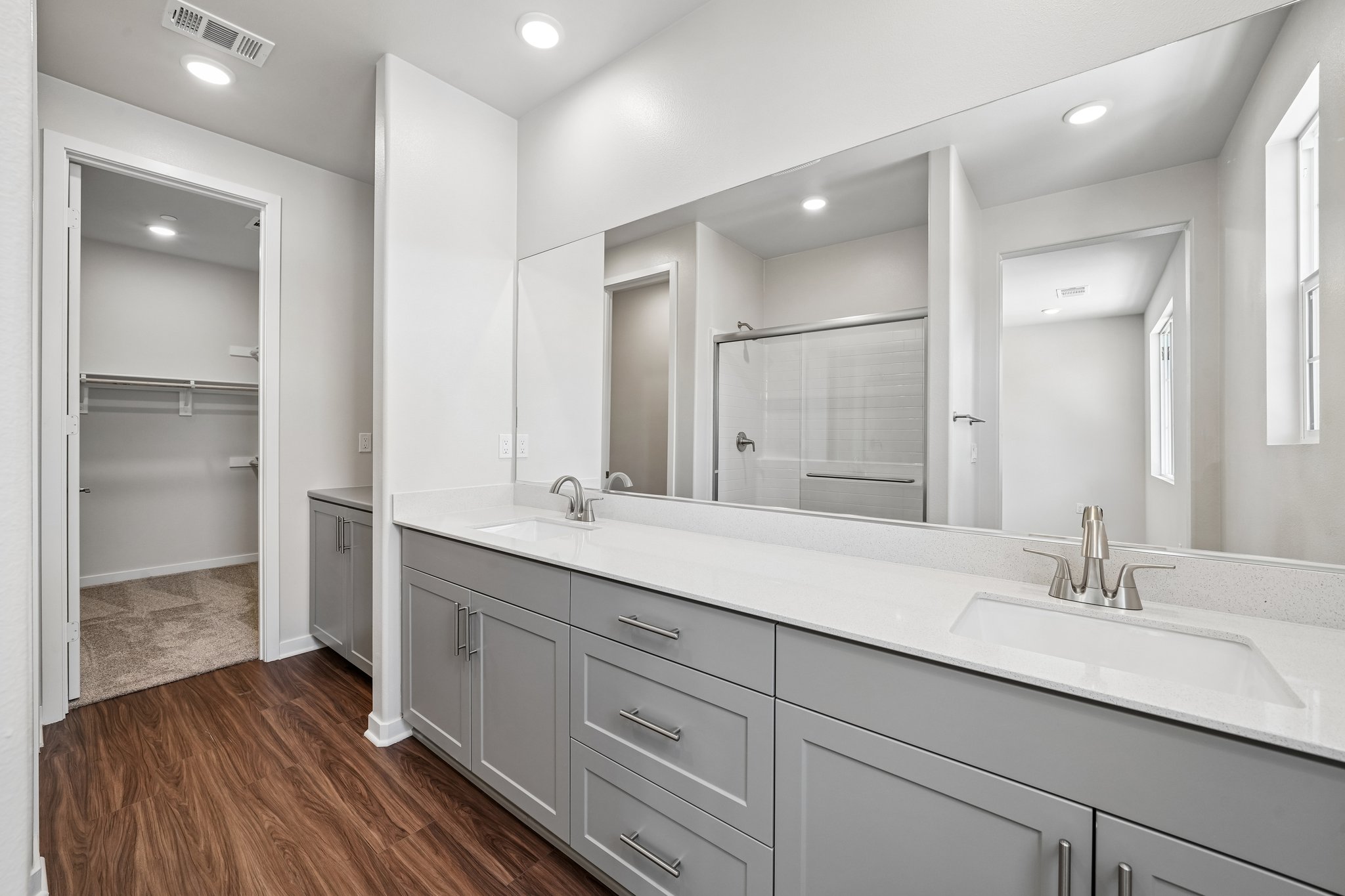 A bathroom with a large mirror.