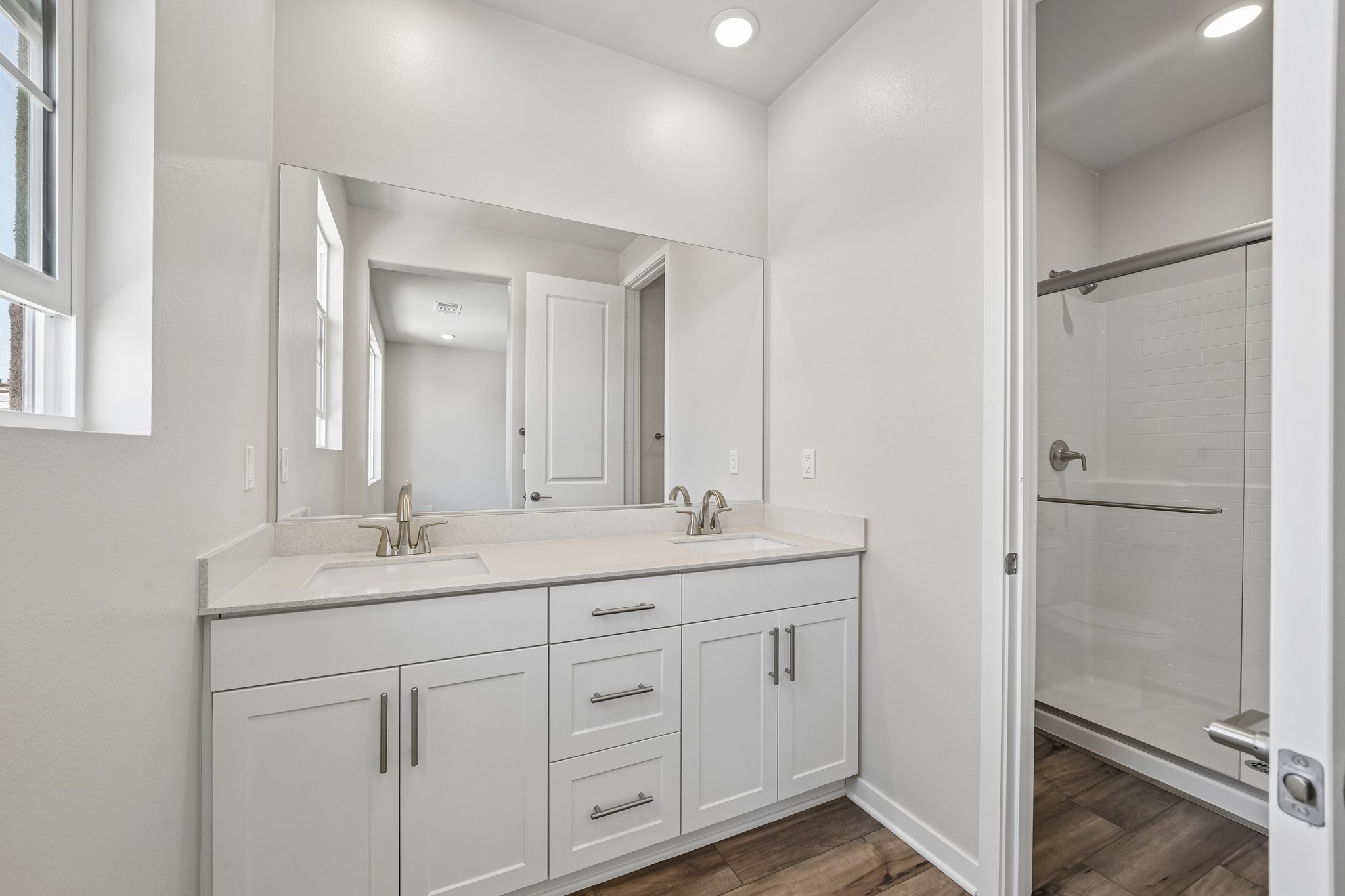 A bathroom with white cabinets.