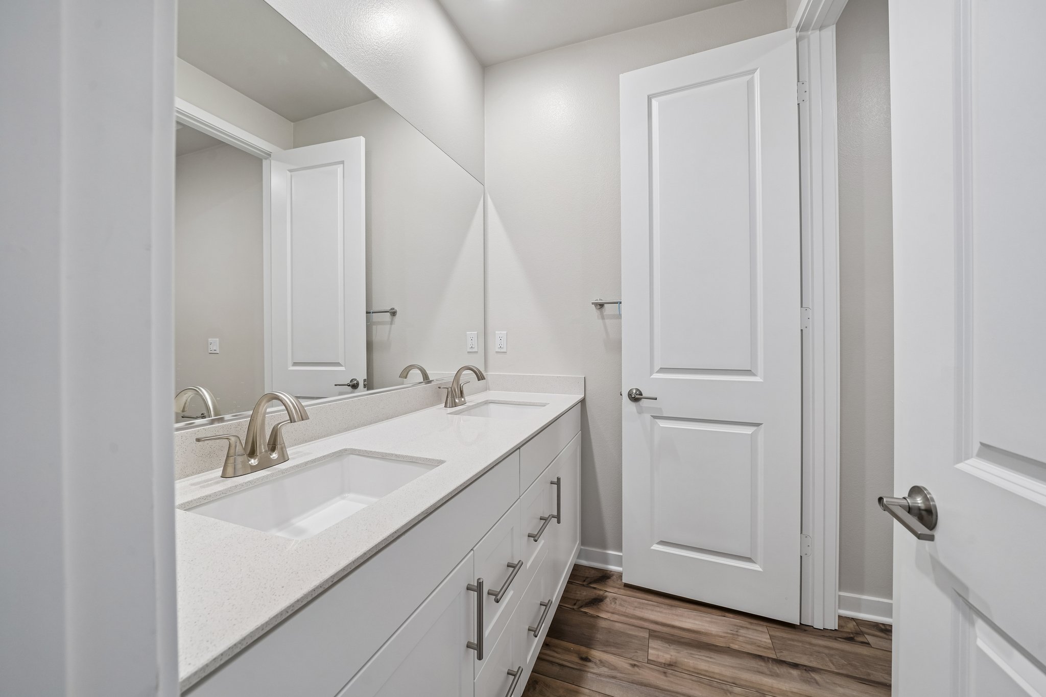 A bathroom with white cabinets.