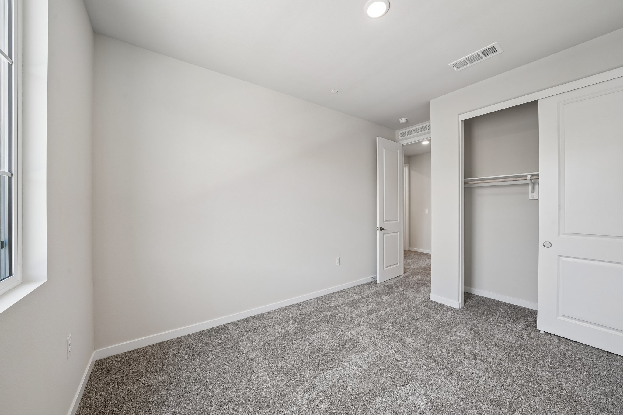 A hallway with white doors.
