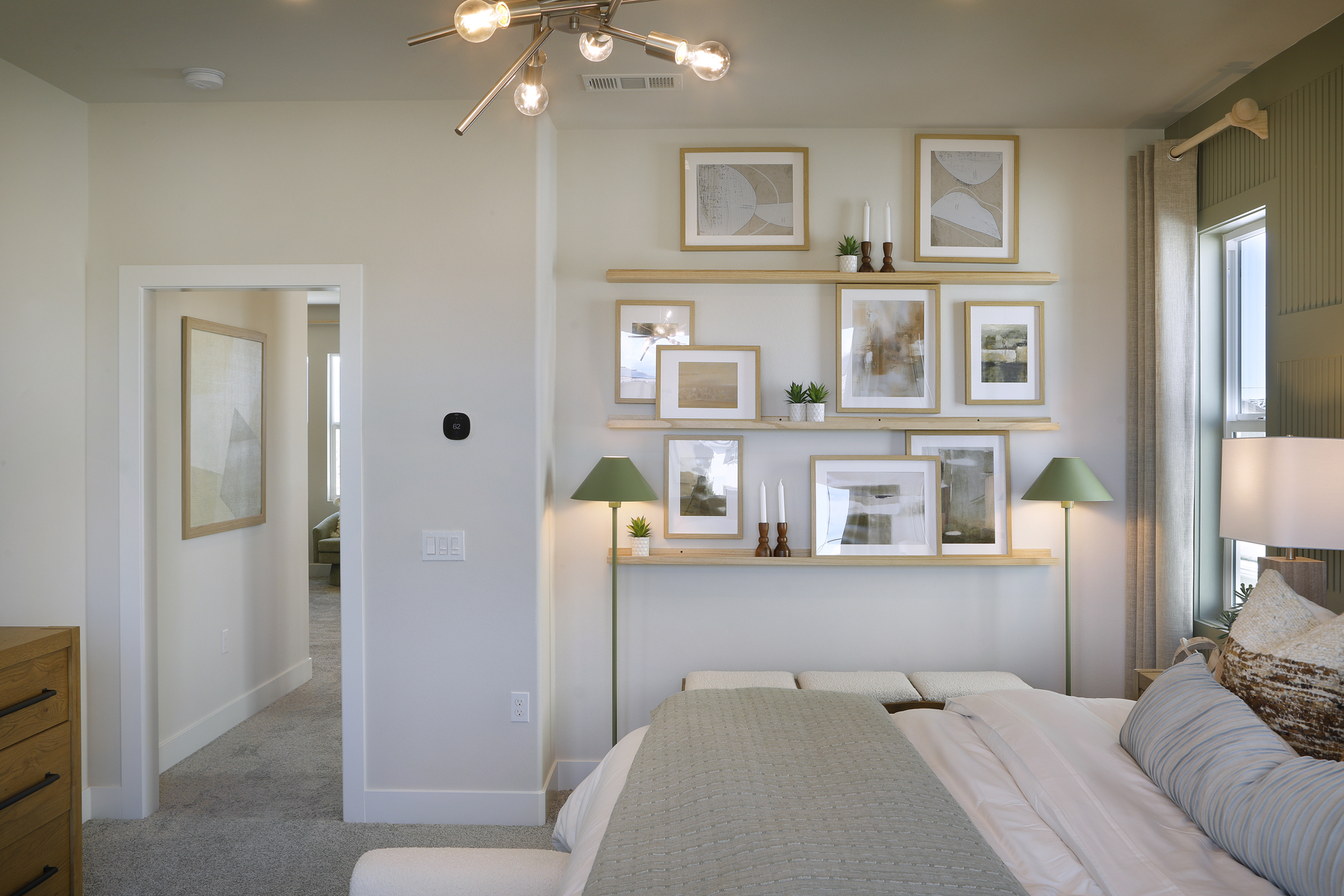 A bedroom with a bed and a lamp.