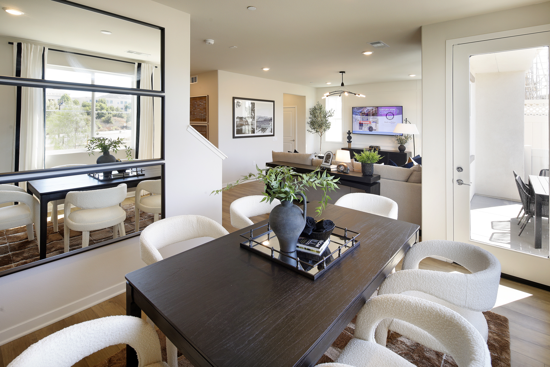 A living room with a large table and chairs.