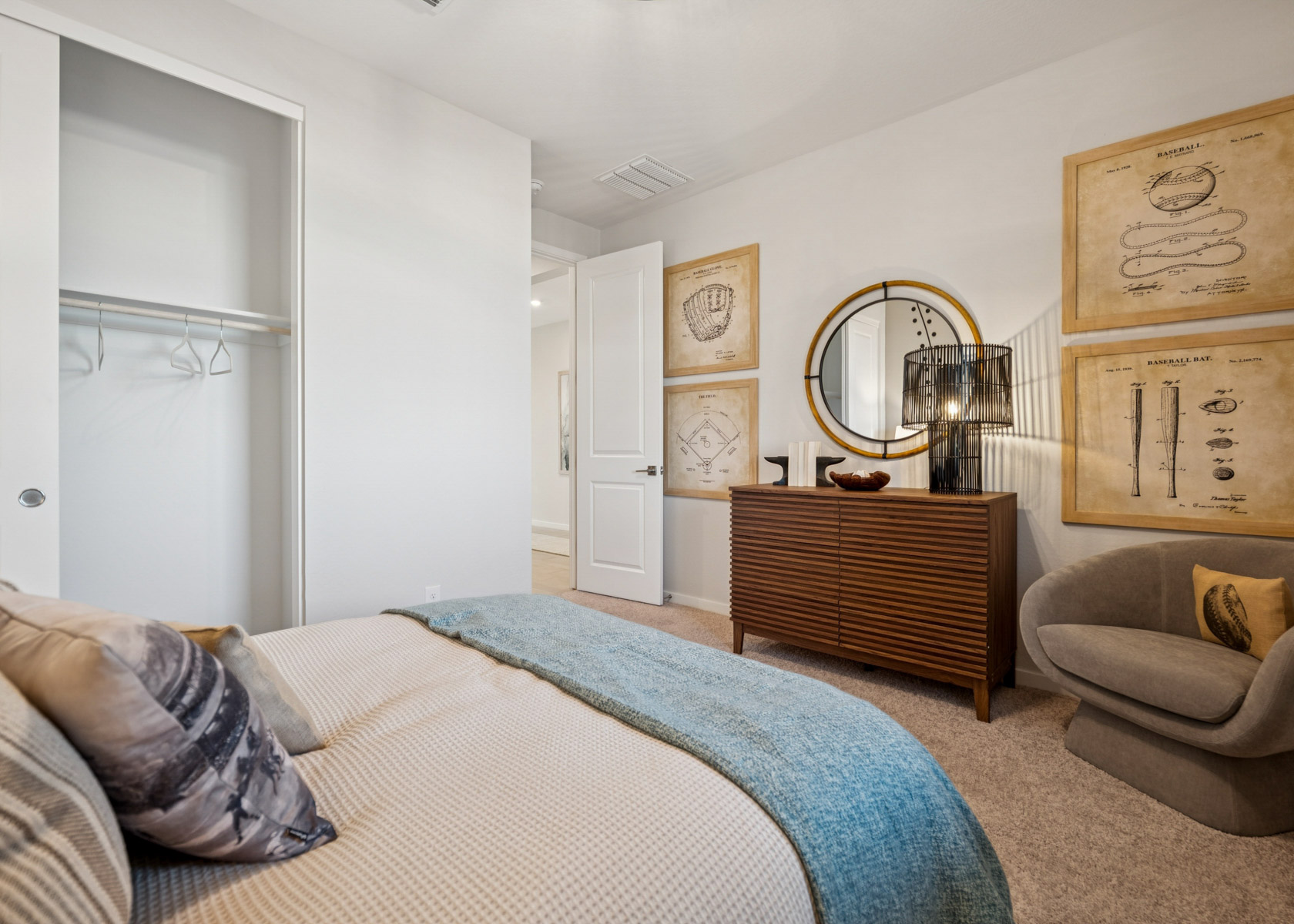 A bedroom with a bed and a mirror.