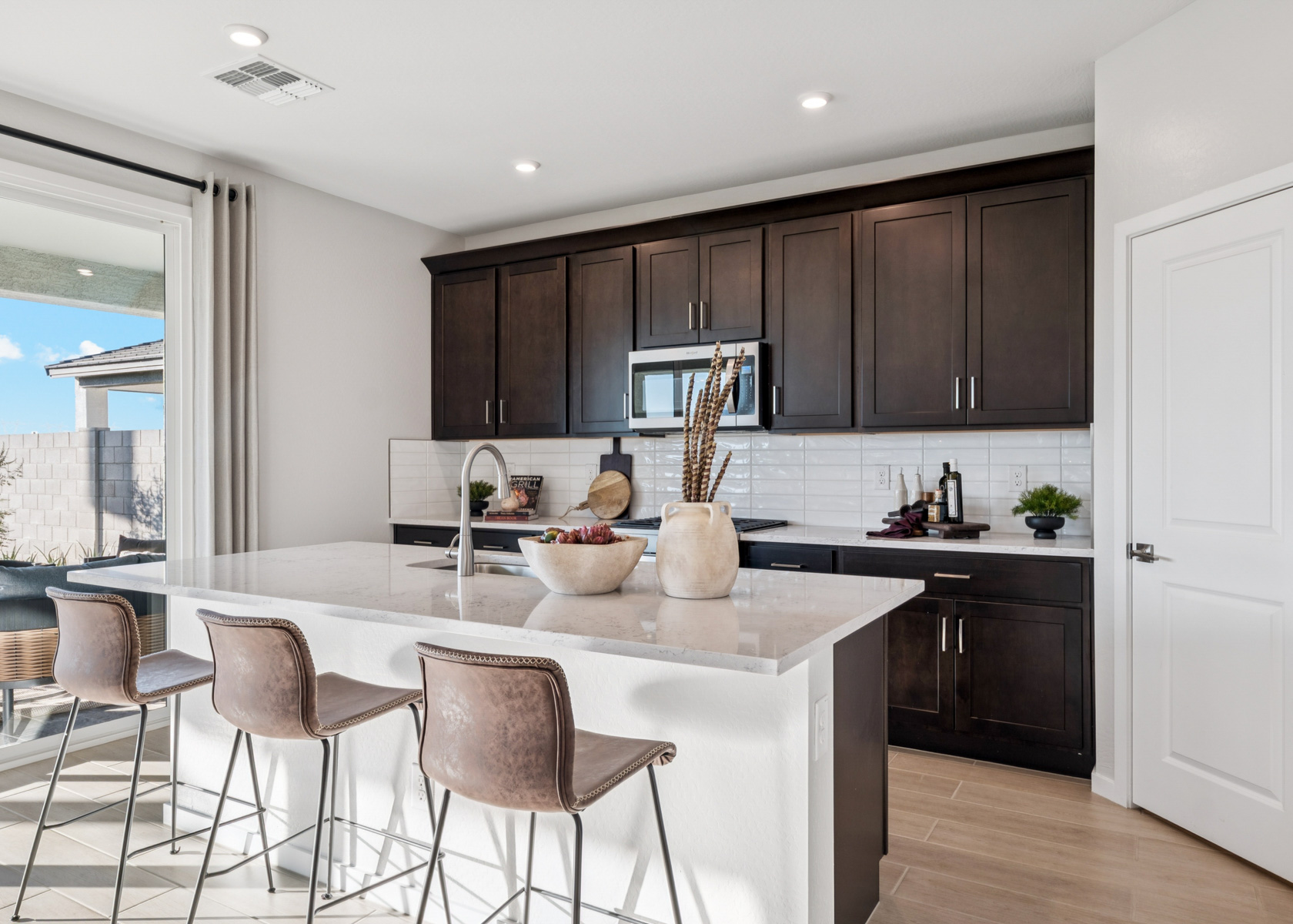 A kitchen with a marble island.