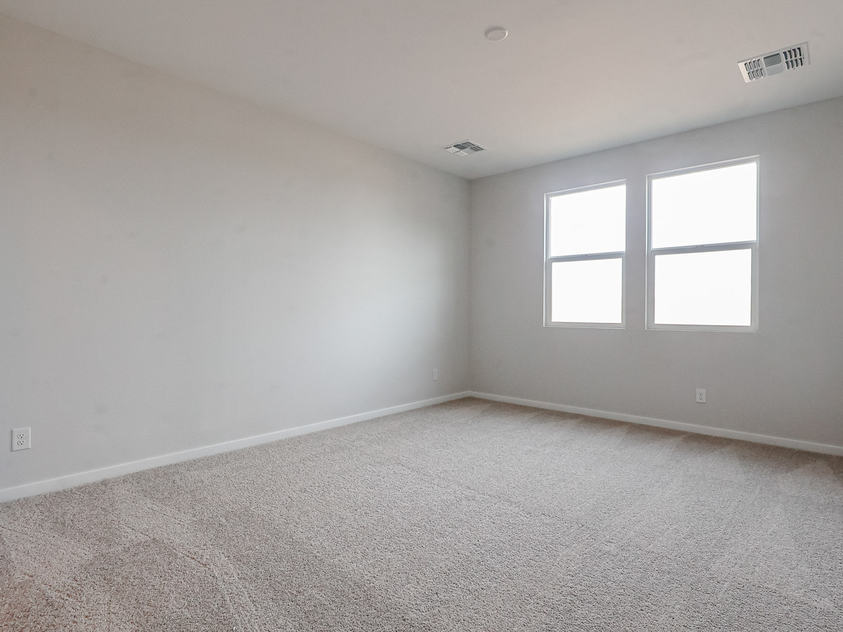 A room with a window and carpet.