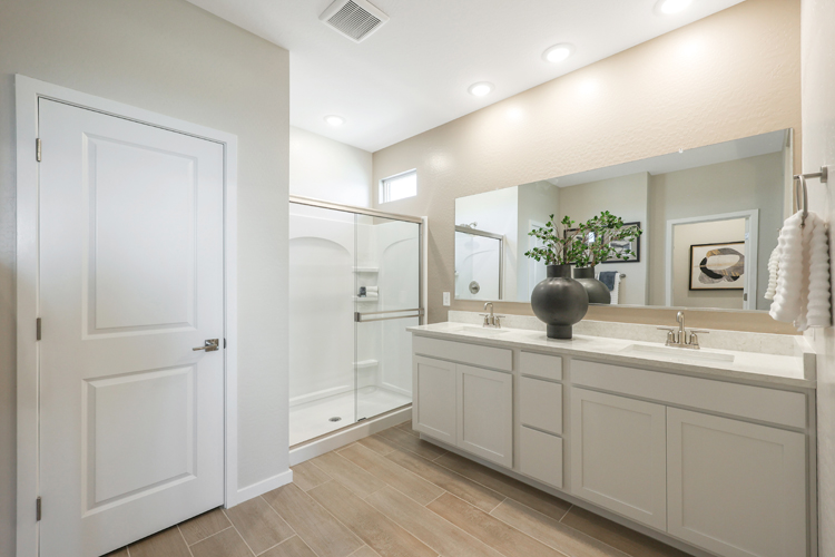 A bathroom with white cabinets.
