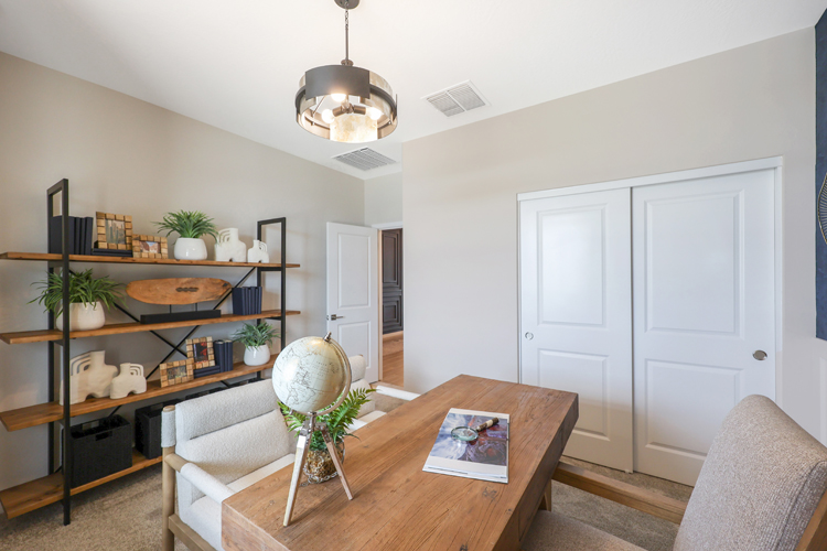 A living room with a table and chairs.