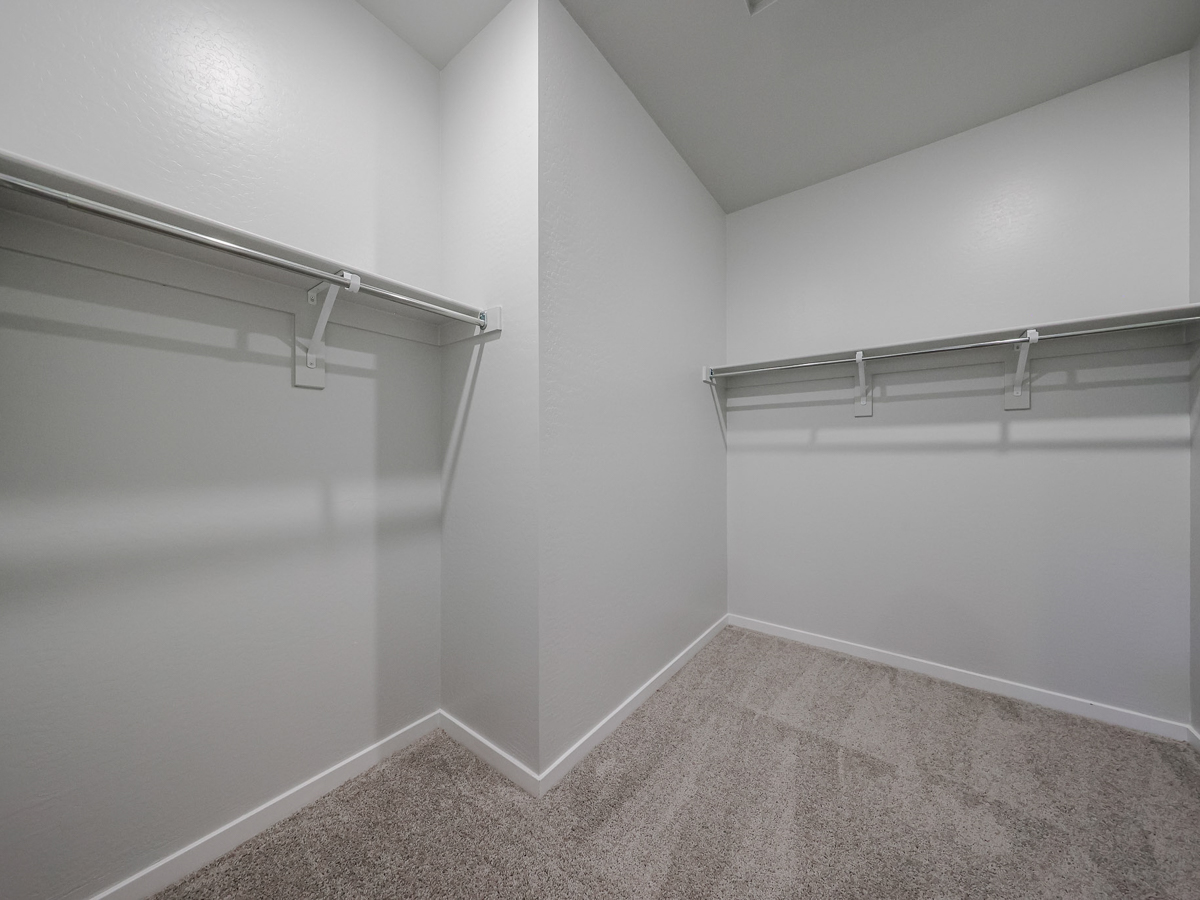 A white room with a metal bar.