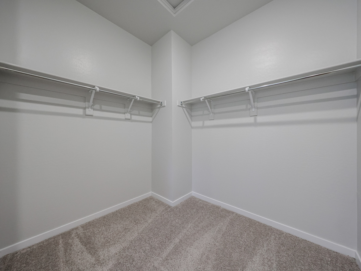 A white wall with a metal bar.