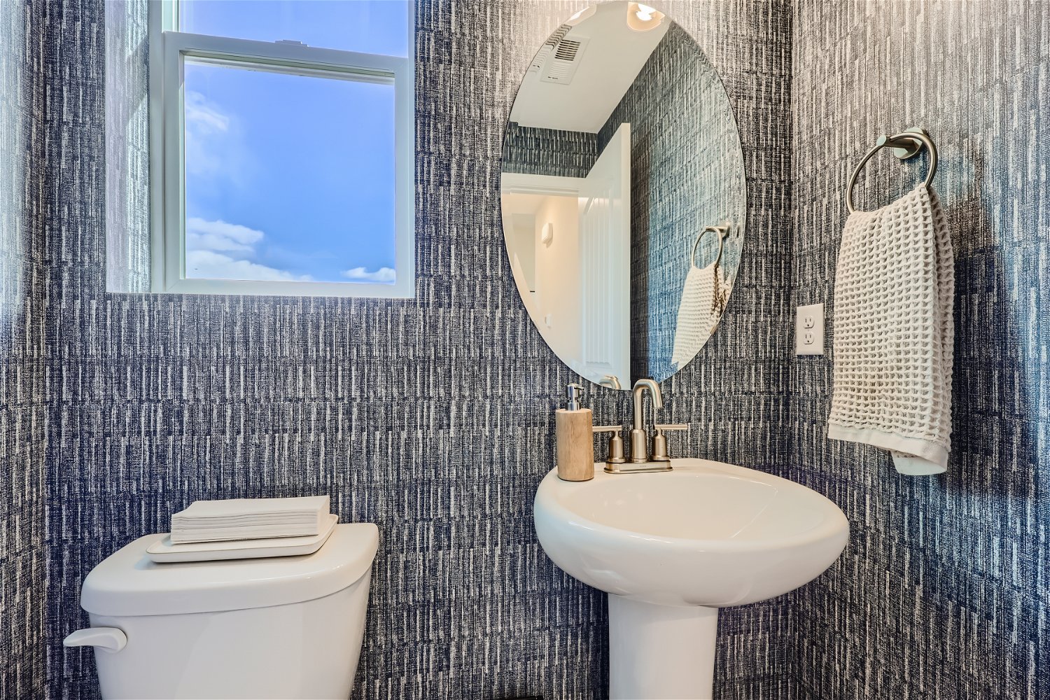 A bathroom with a mirror and a sink.