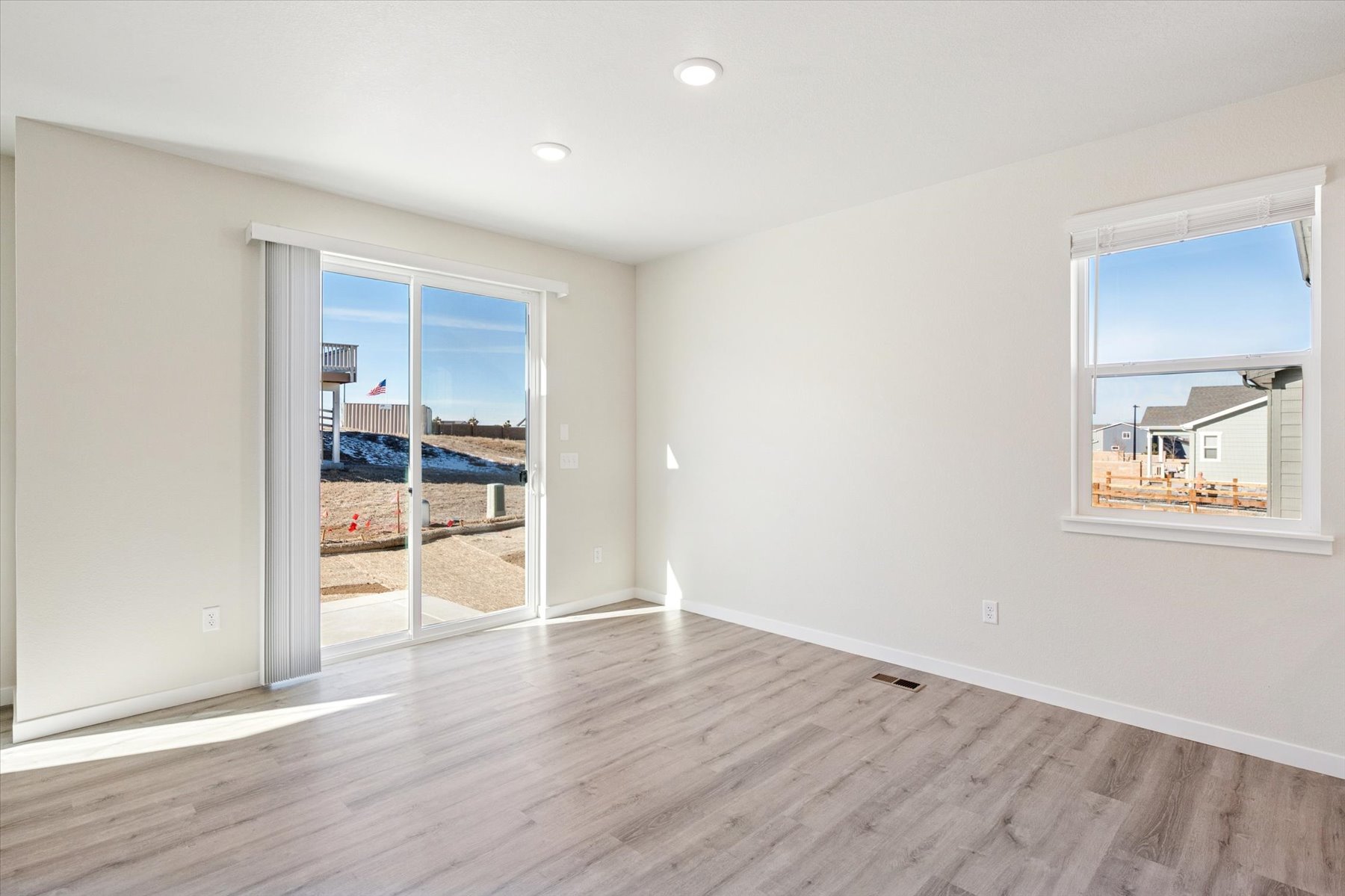 A room with a wood floor and a wood floor with a window.