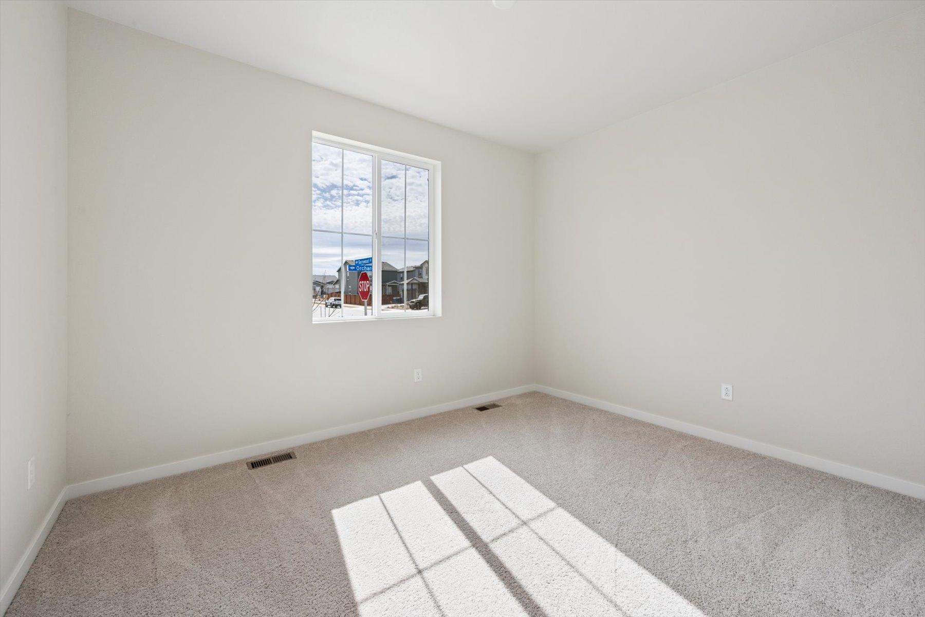 A room with a window and a tile floor.