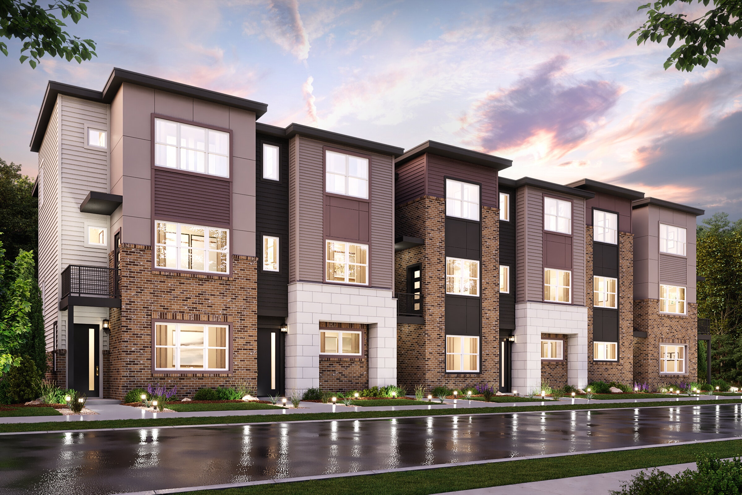 A large brick building with a pond in front of it.