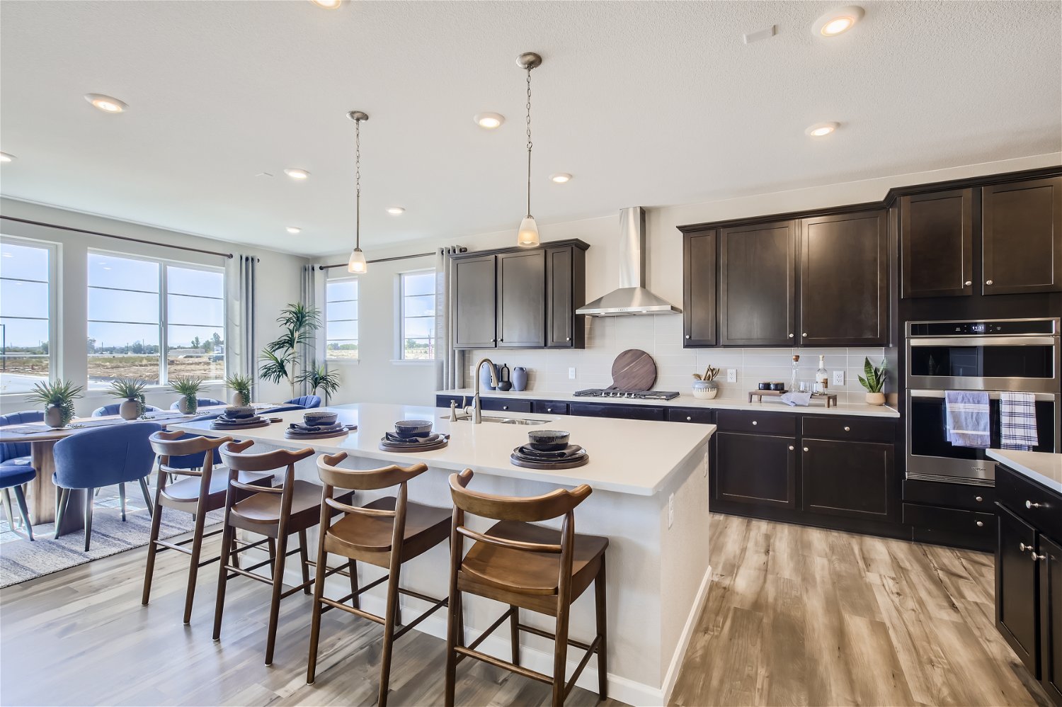 A kitchen with a dining table and chairs.