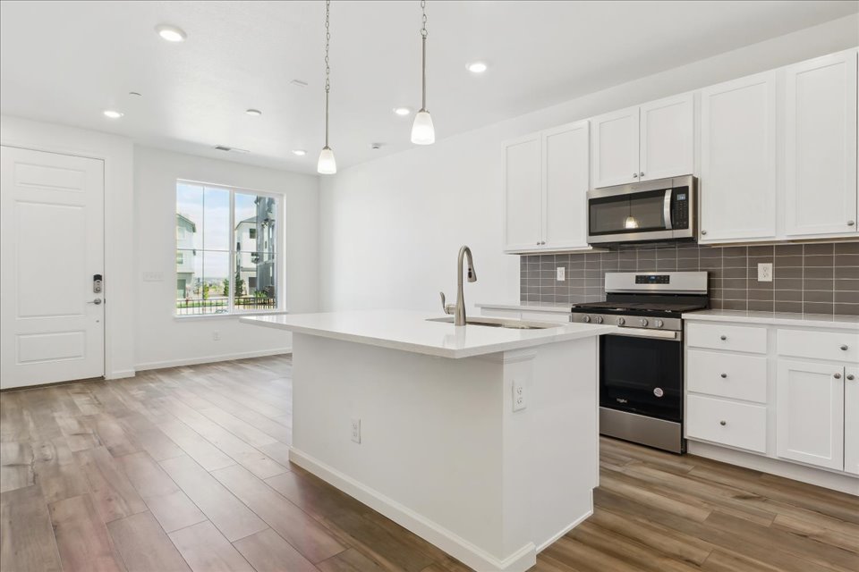 A kitchen with white cabinets.