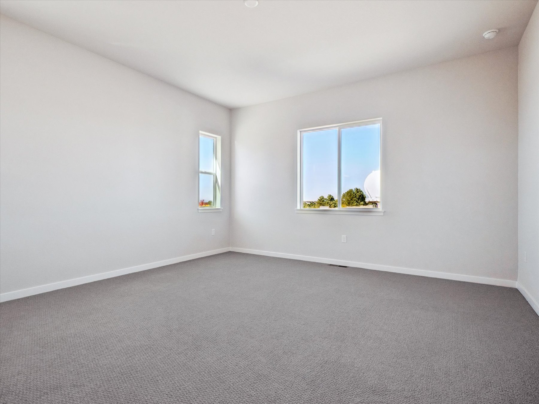 A room with a window and a carpet.