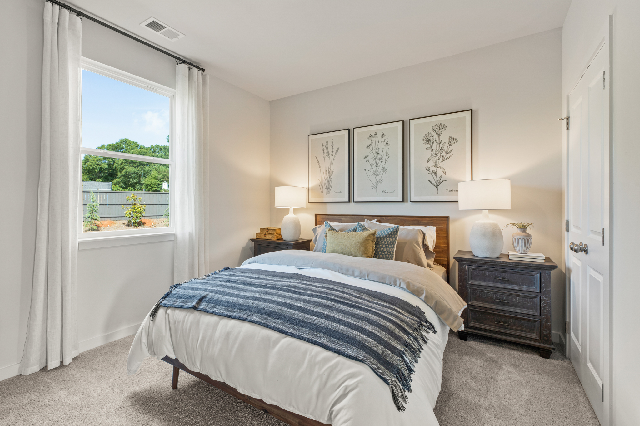 A bedroom with a bed and a window.