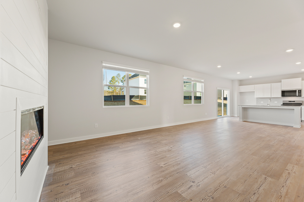 A room with a wood floor and a wood floor with a window.