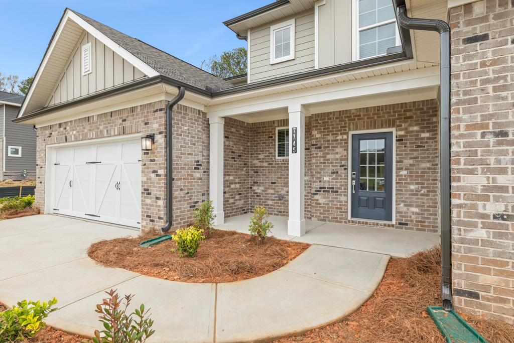 A brick house with a small garden.