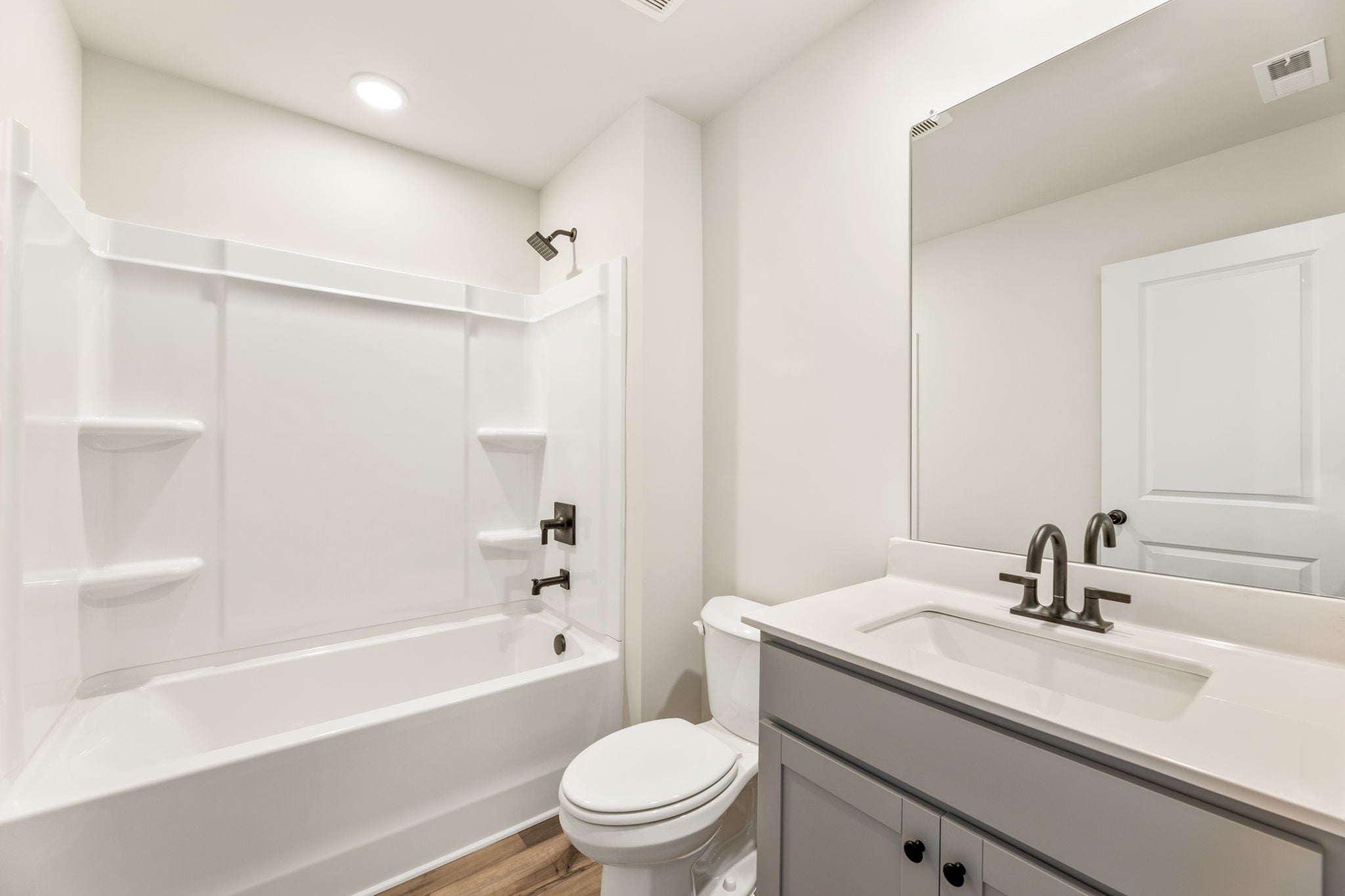 A bathroom with a tub sink and toilet.