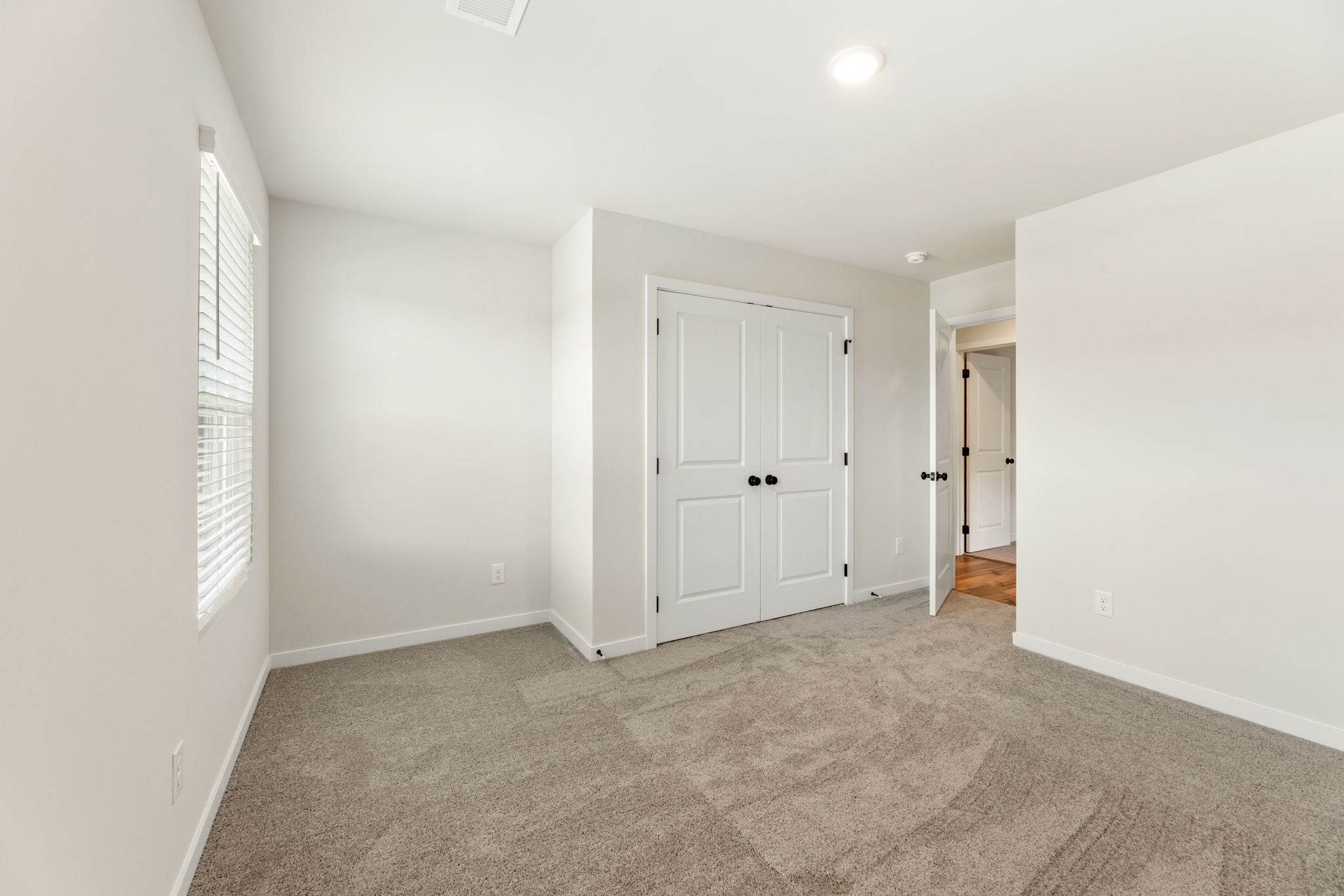 A hallway with white doors.