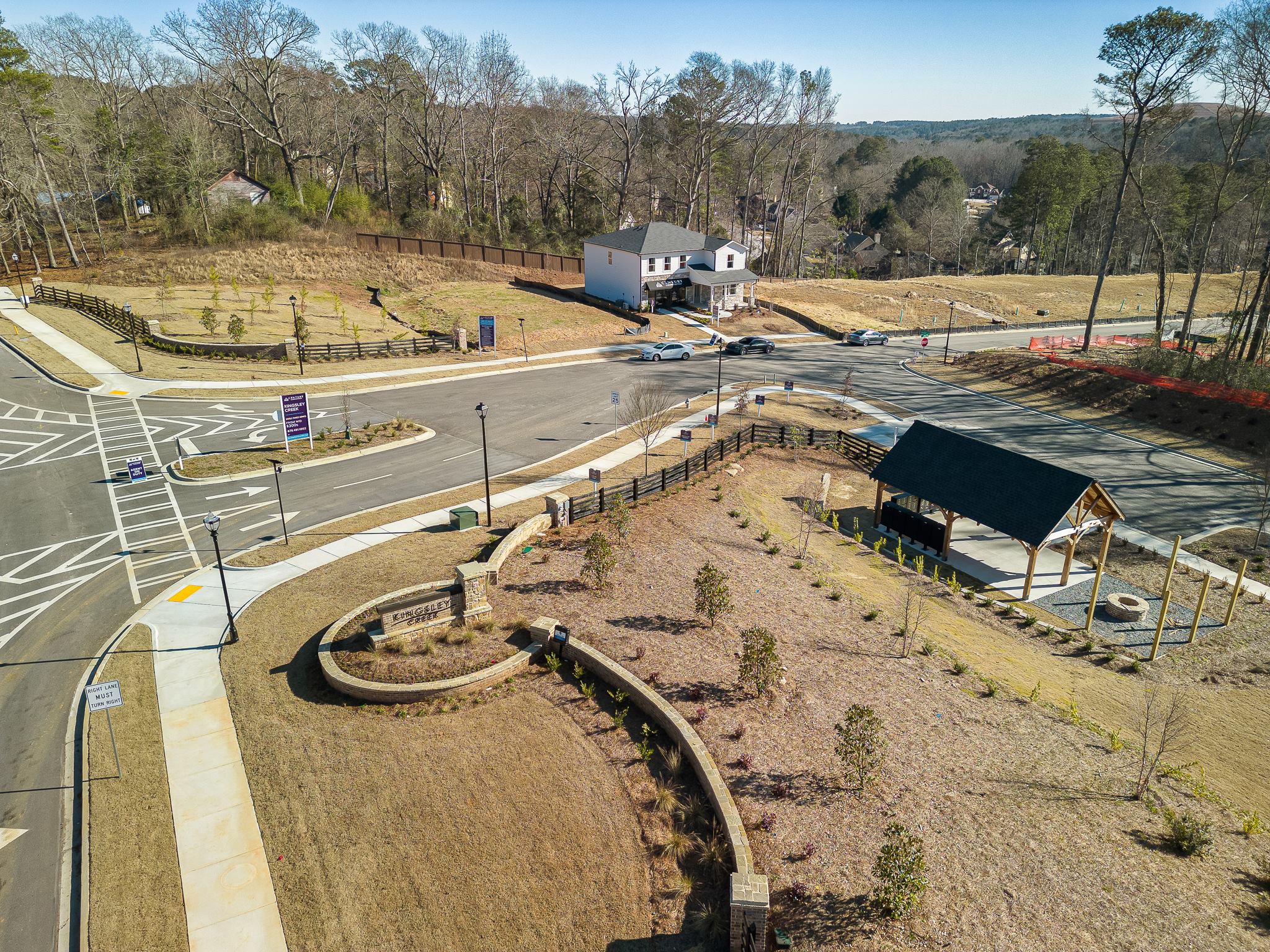 A road with a building and trees on the side.