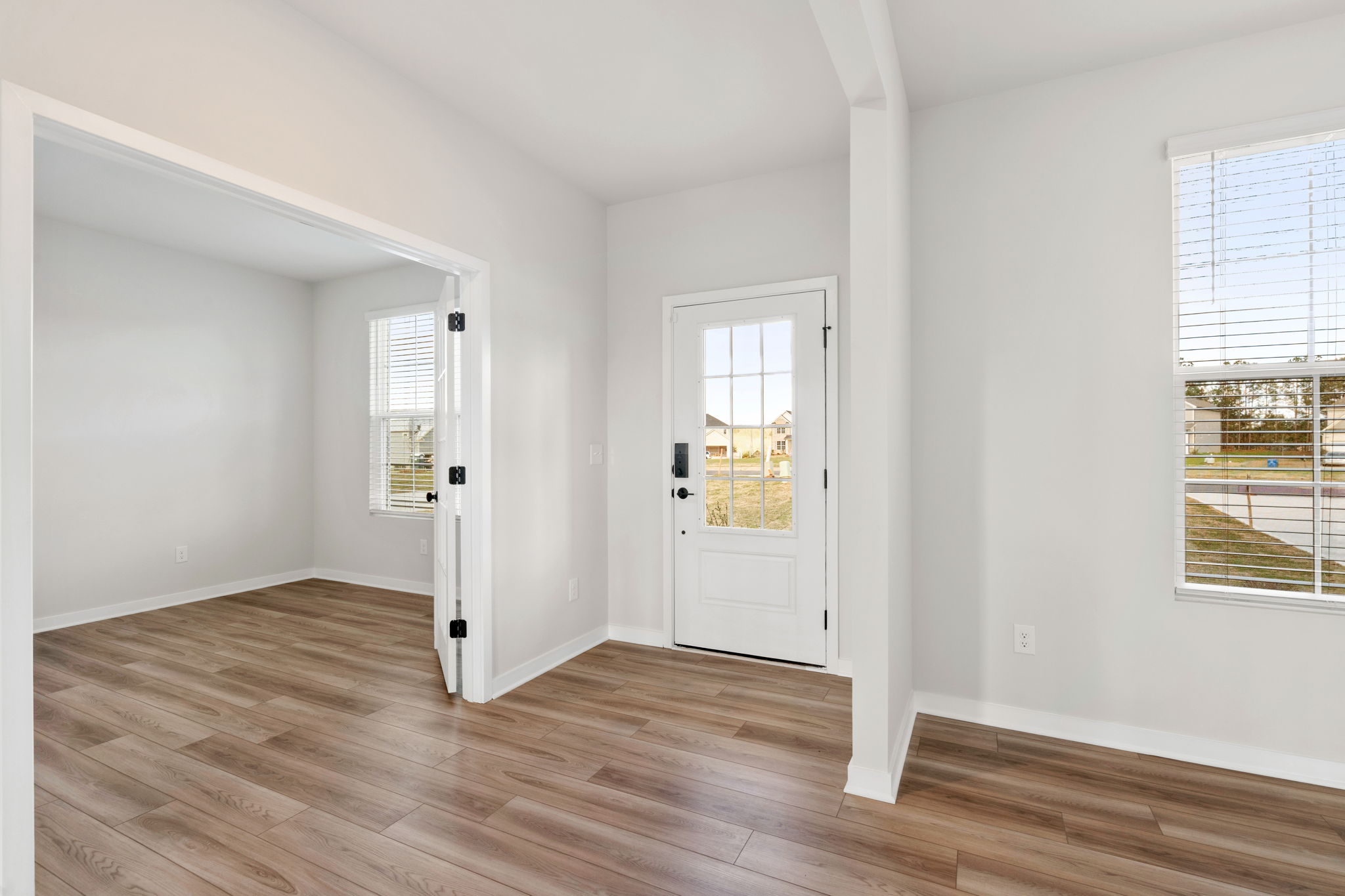 A room with white walls and a wood floor.