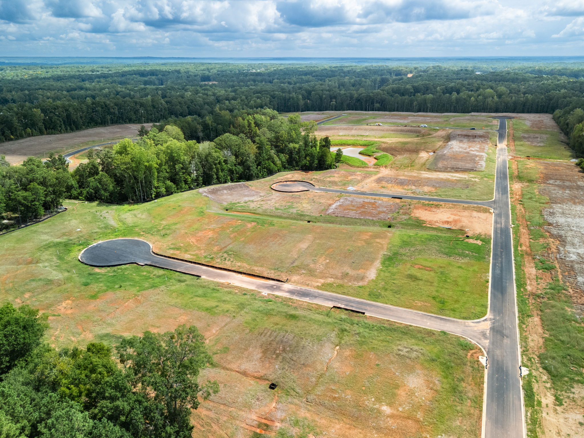 A large field with a river running through it.