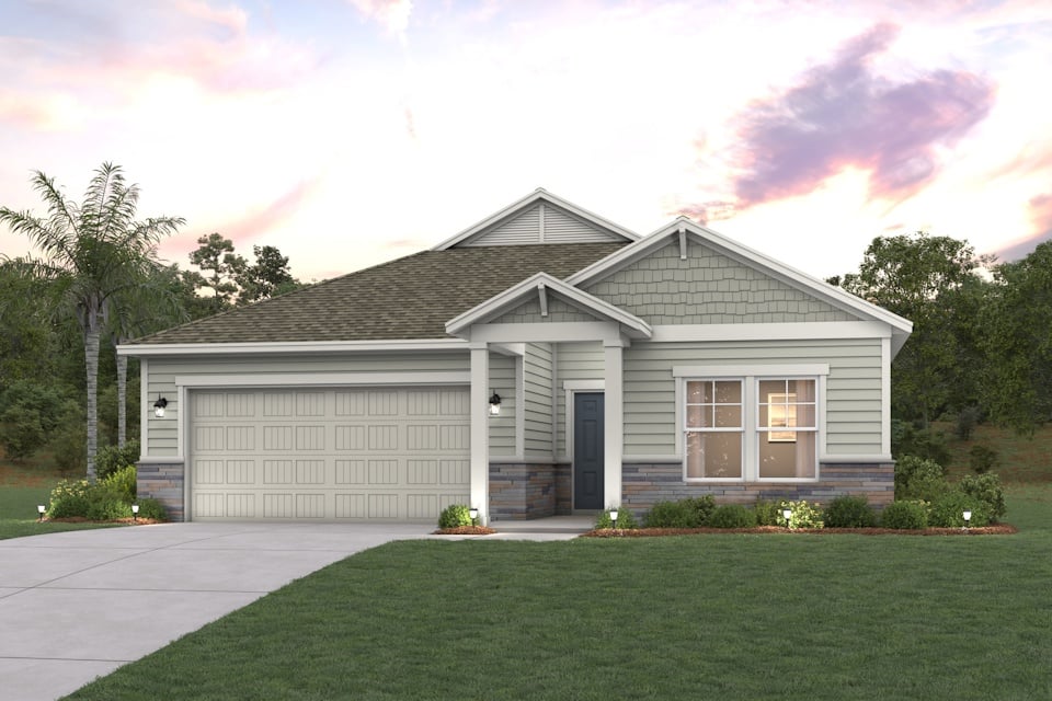 A house with a garage and trees in the back.