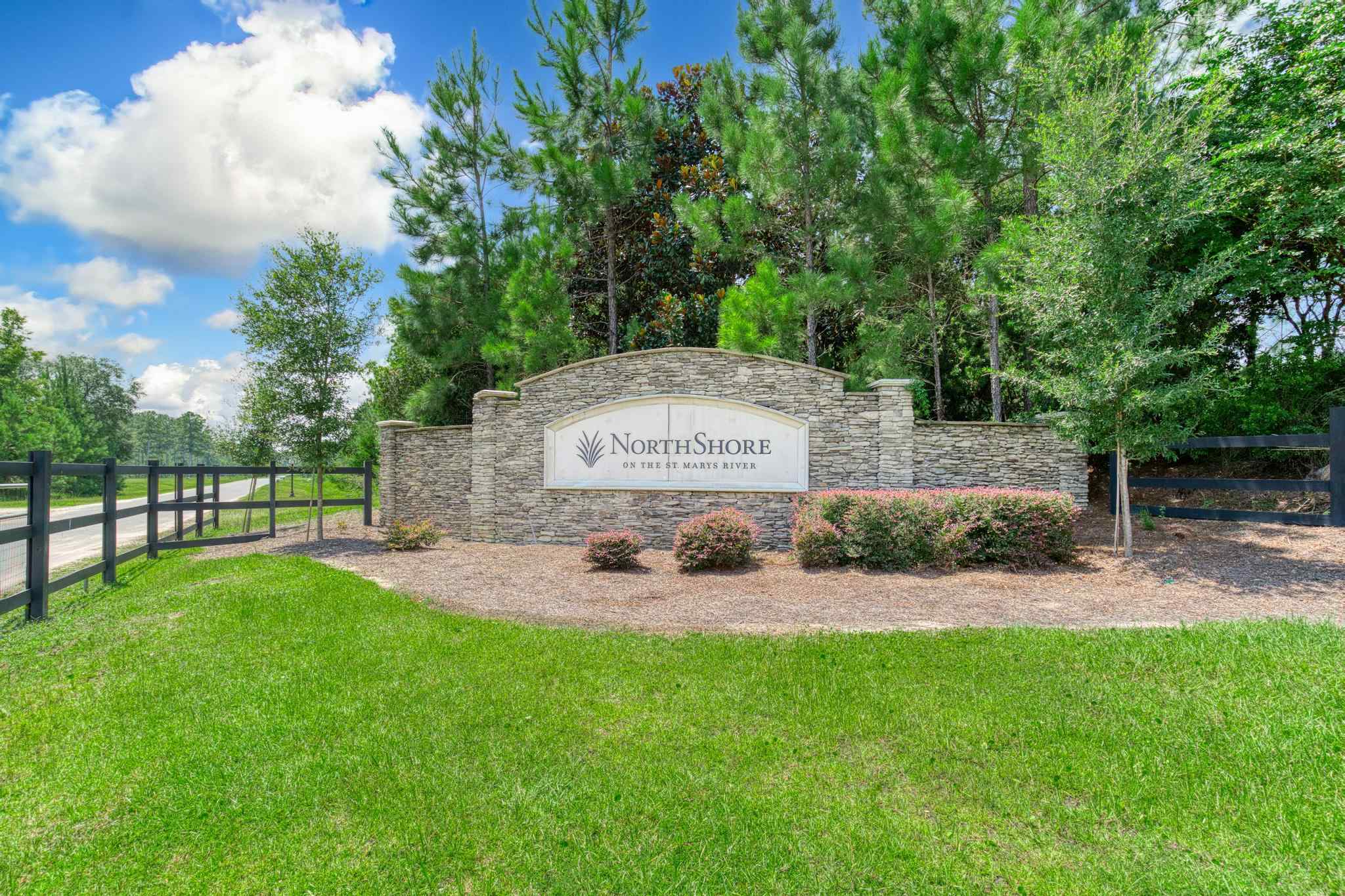 A sign on a stone wall.