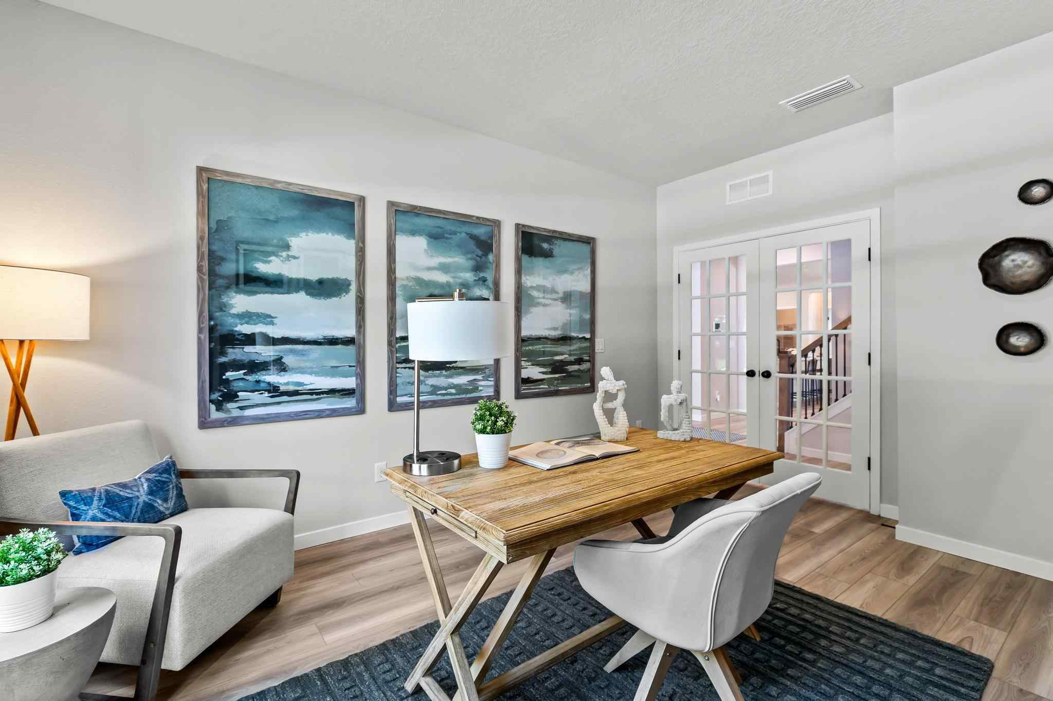 A living room with a table and chairs.