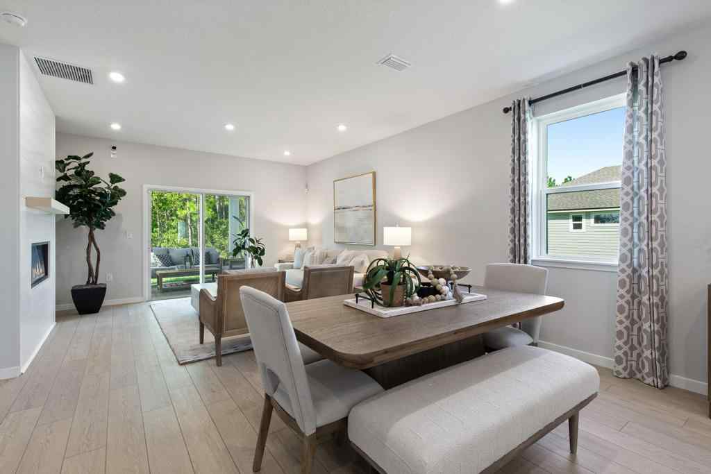 A large room with a table and chairs.