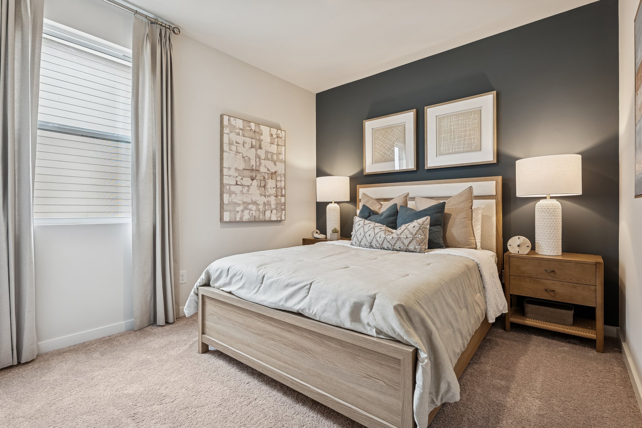 A bedroom with a bed and lamps.