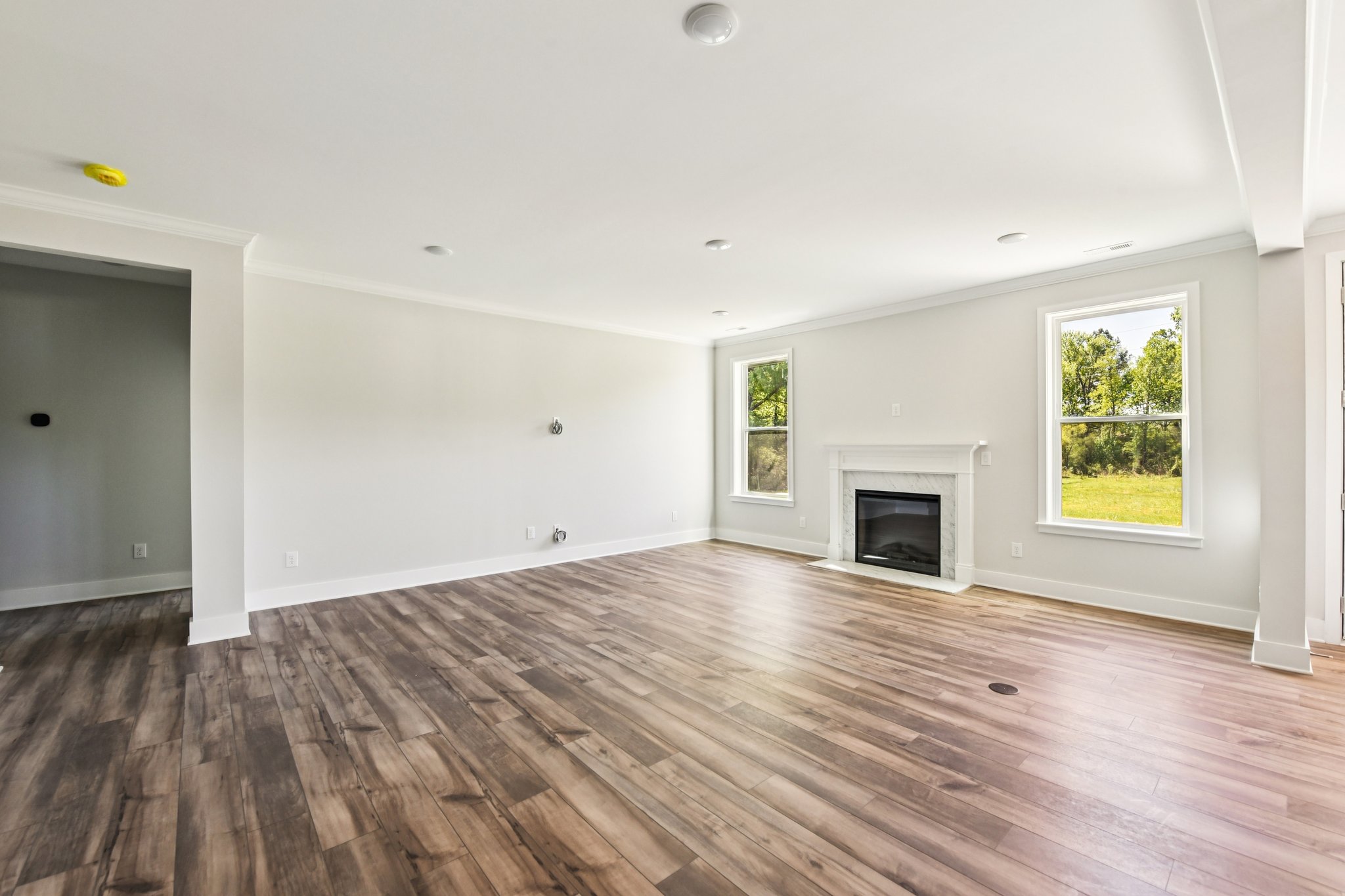 A room with a fireplace and a wood floor.