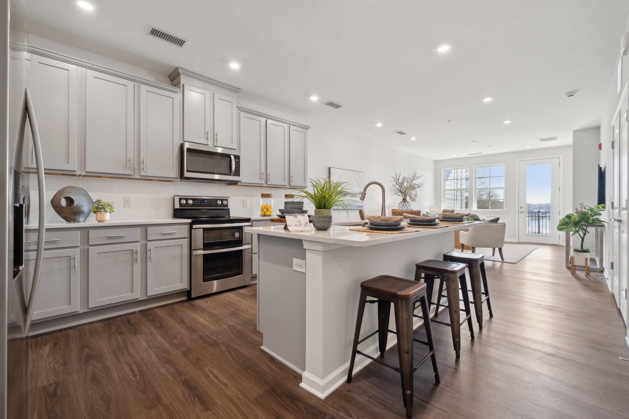 A kitchen with white cabinets.