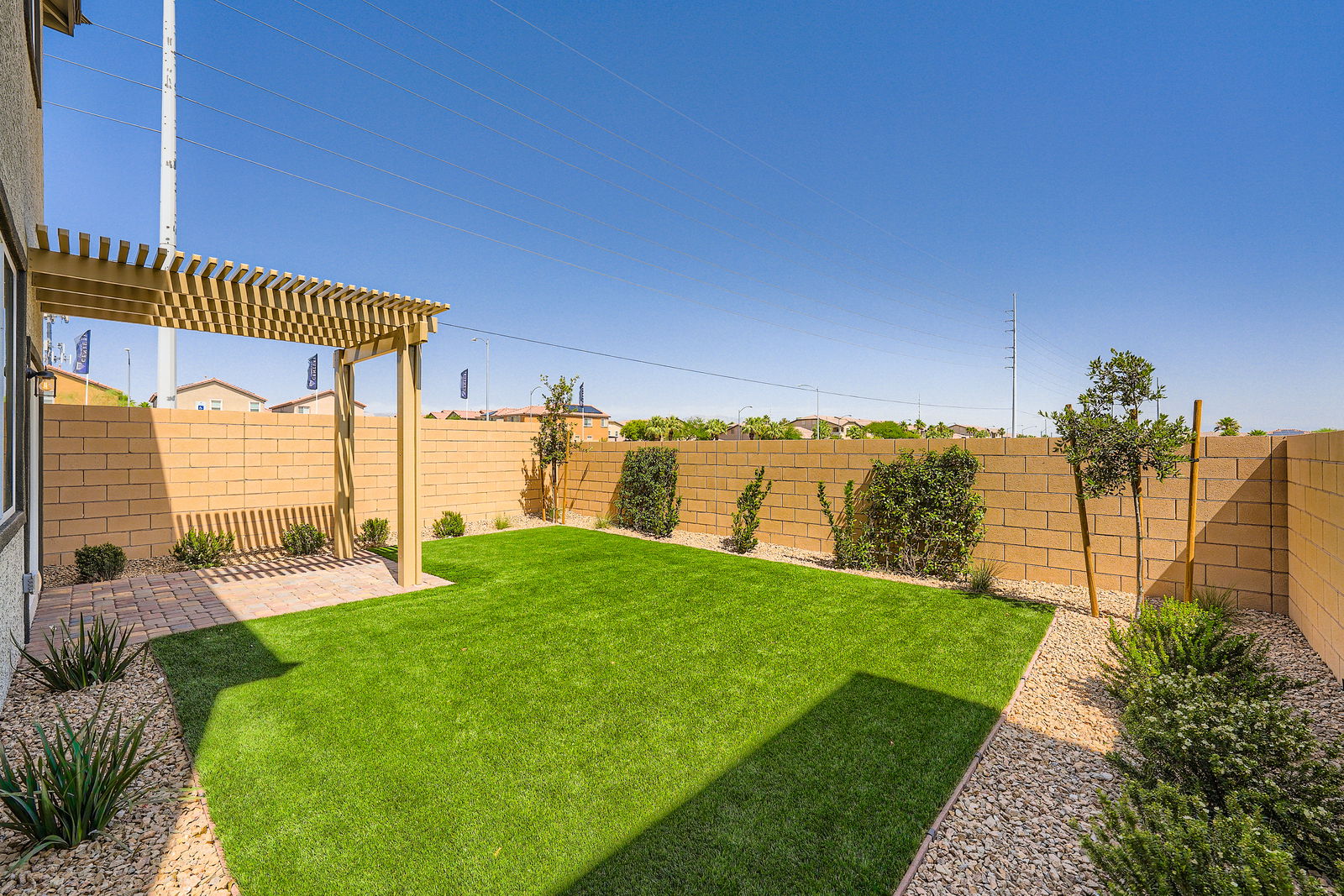 A backyard with a brick wall and a brick fence.