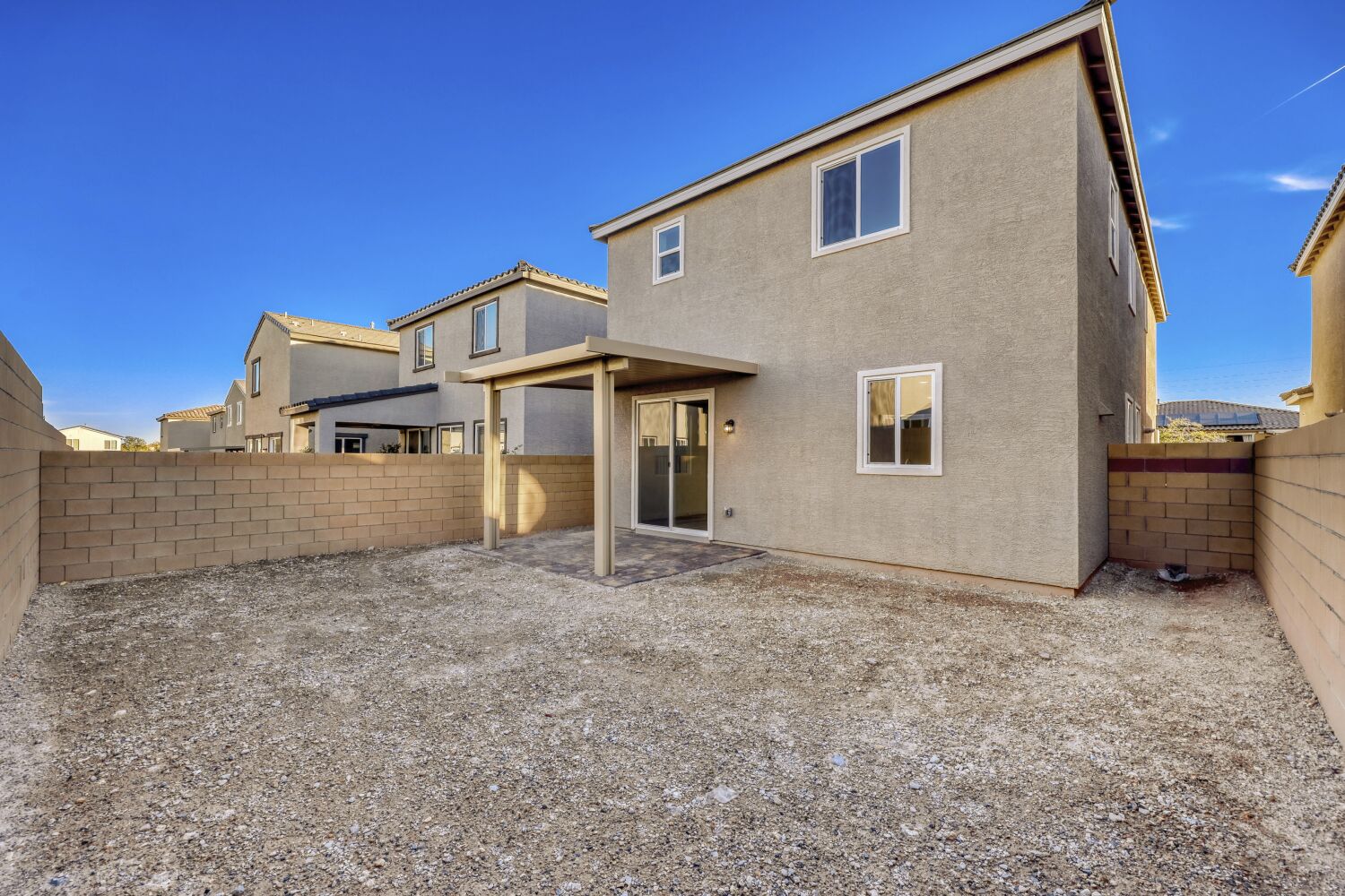 A house with a gravel driveway.