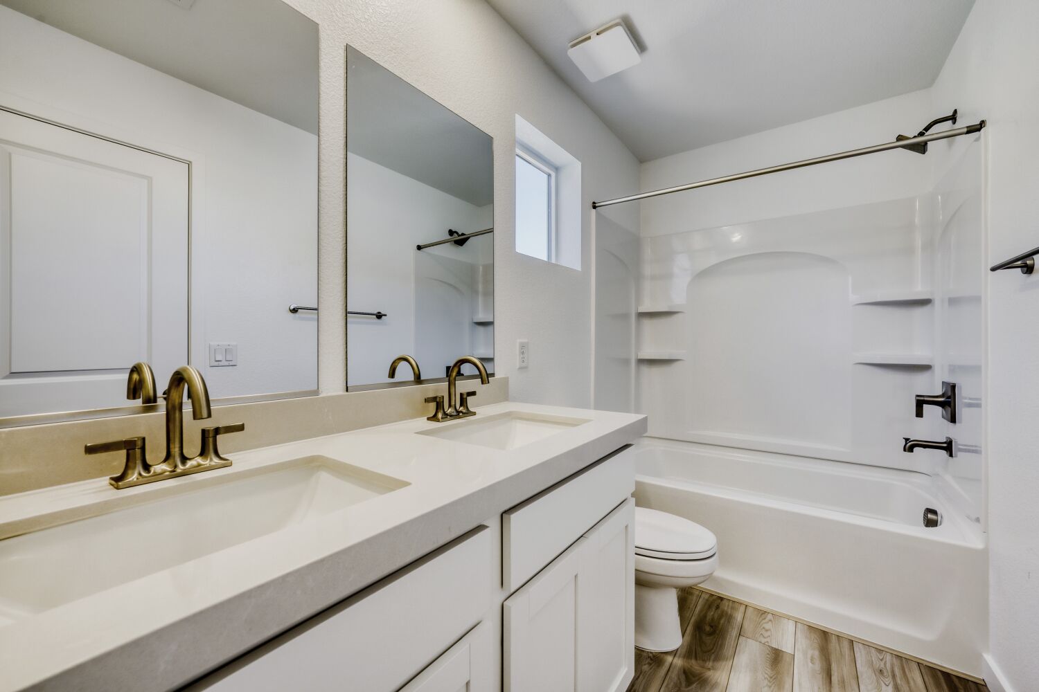 A bathroom with a tub sink and toilet.