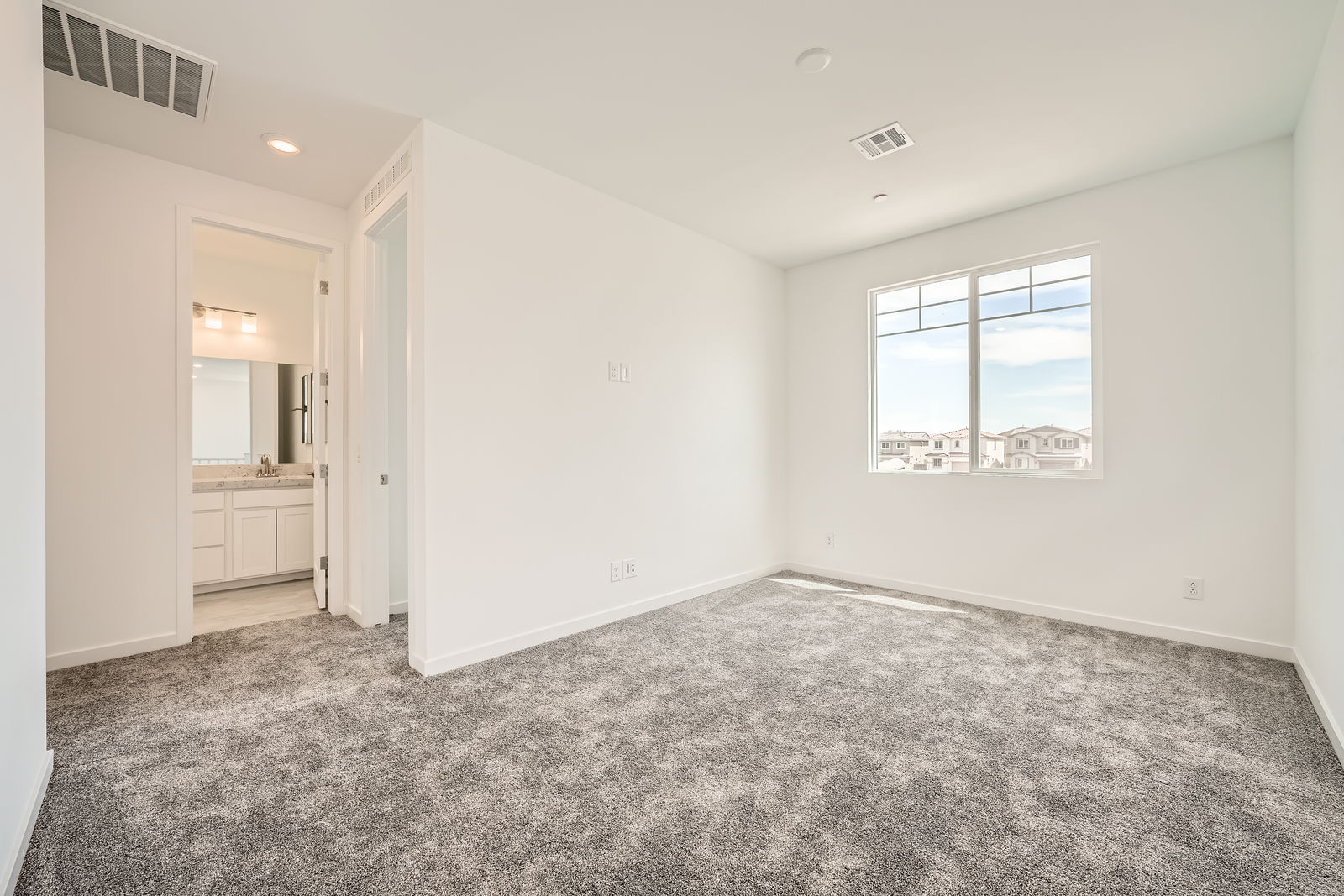 A room with a window and a desk.