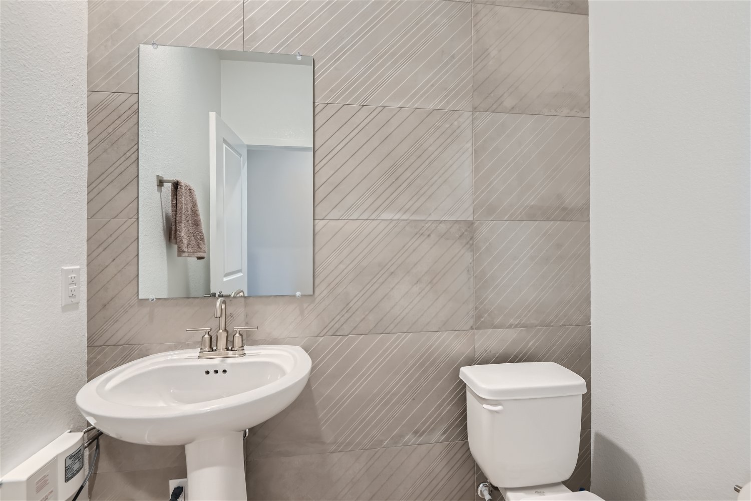 A bathroom with a sink and toilet.