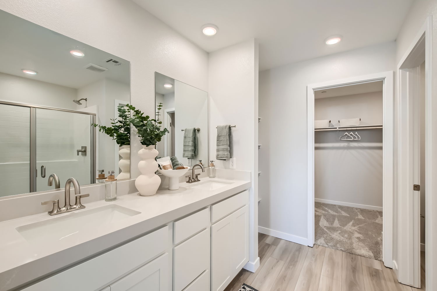 A bathroom with a tub sink and a mirror.