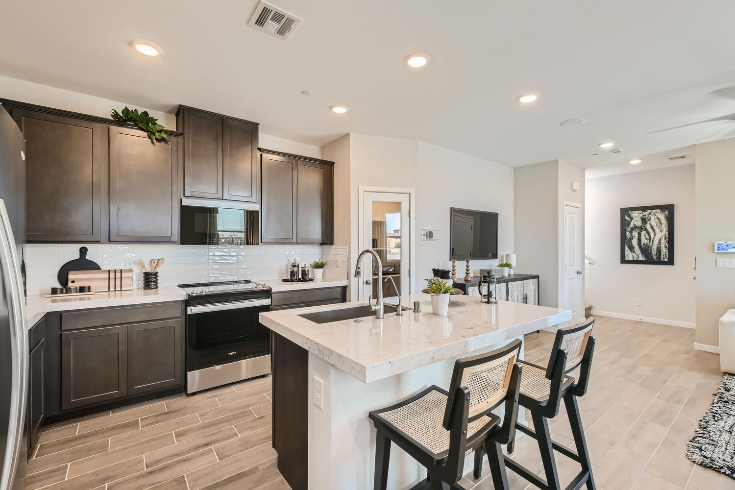 A kitchen with a table and chairs.