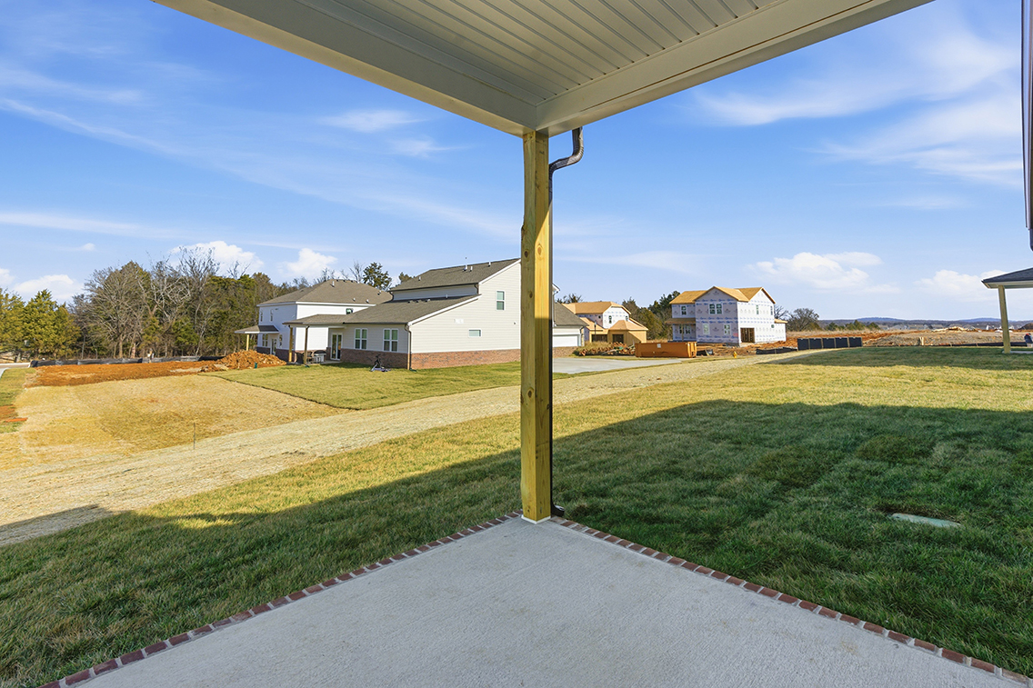 A grassy field with a building in the background.
