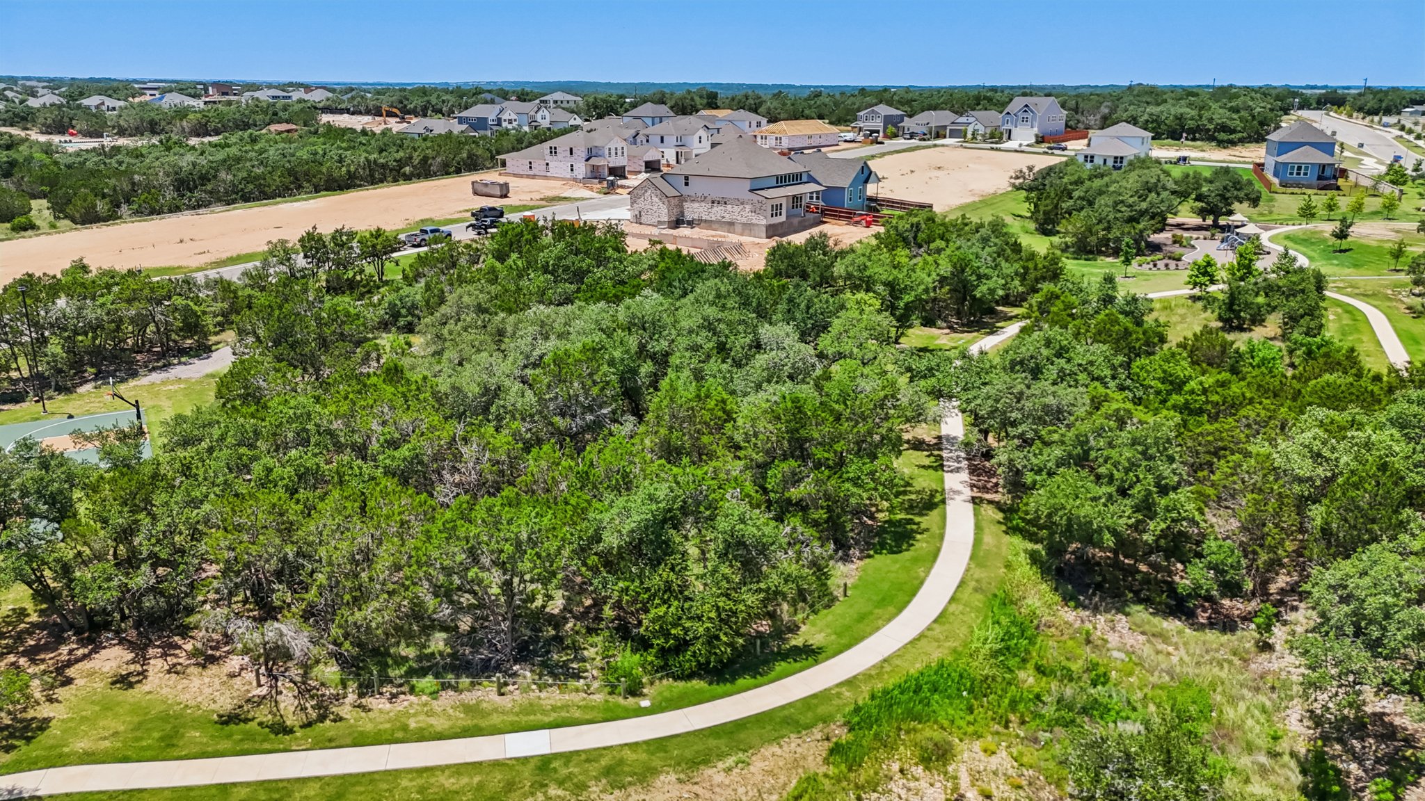 A group of houses in a wooded area.