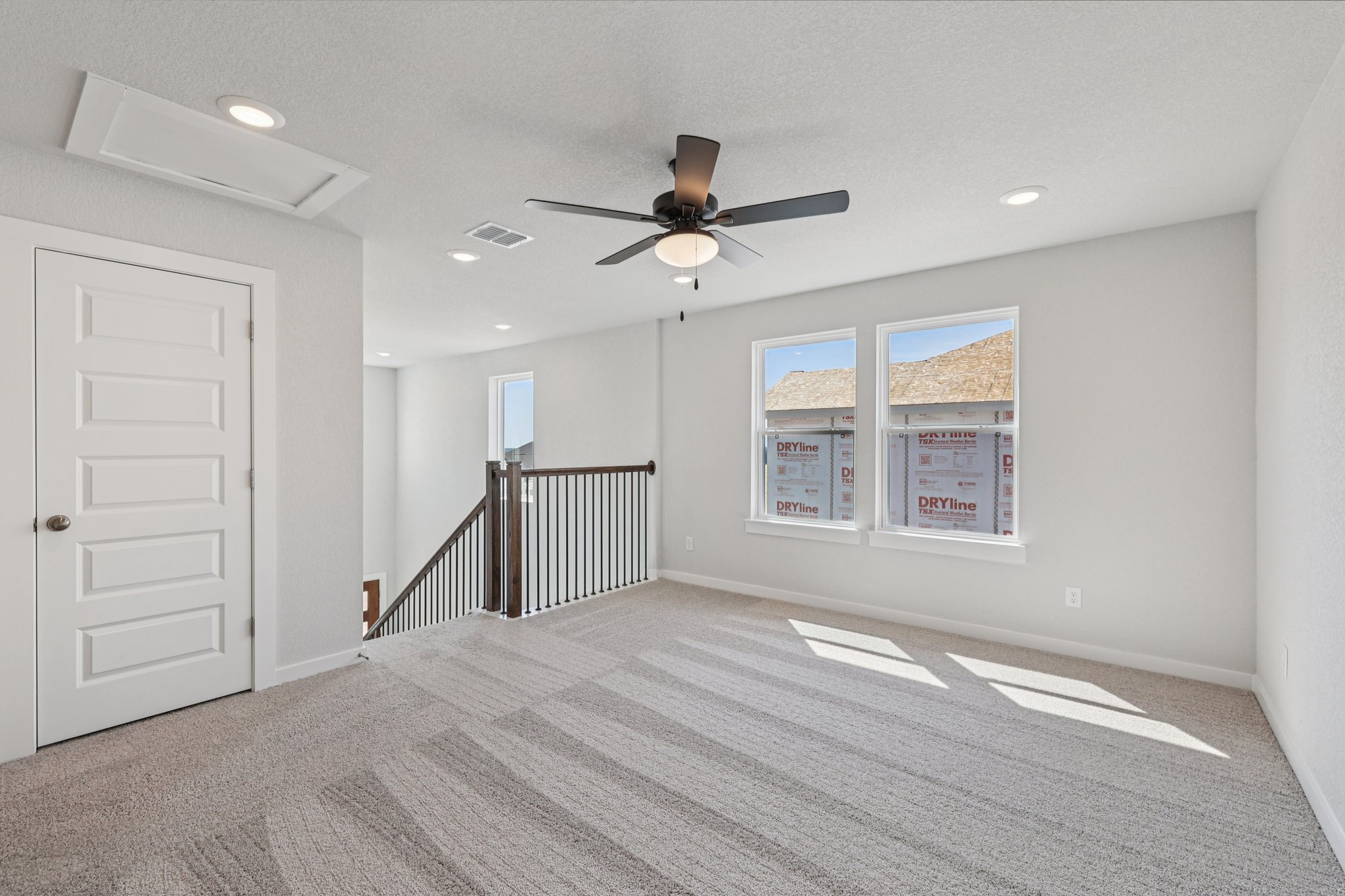 A room with a fan and a door.